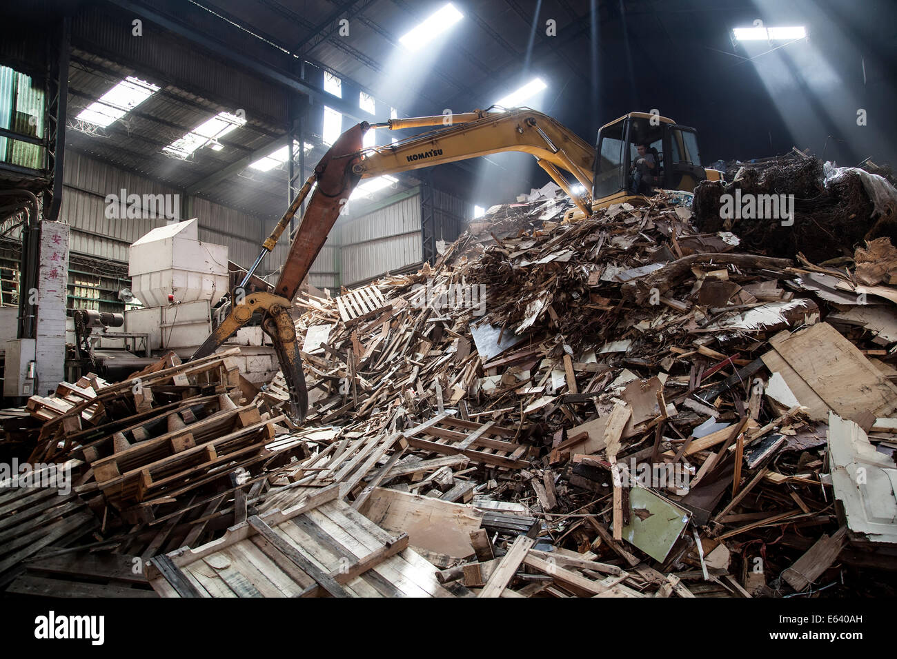 Heavy duty machinery used for dealing with a pile of waste timber in a Taipei's wood recycling factory. On July 27, 2014 in Taipei, Taiwan. (CTK Photo/Karel Picha) Stock Photo