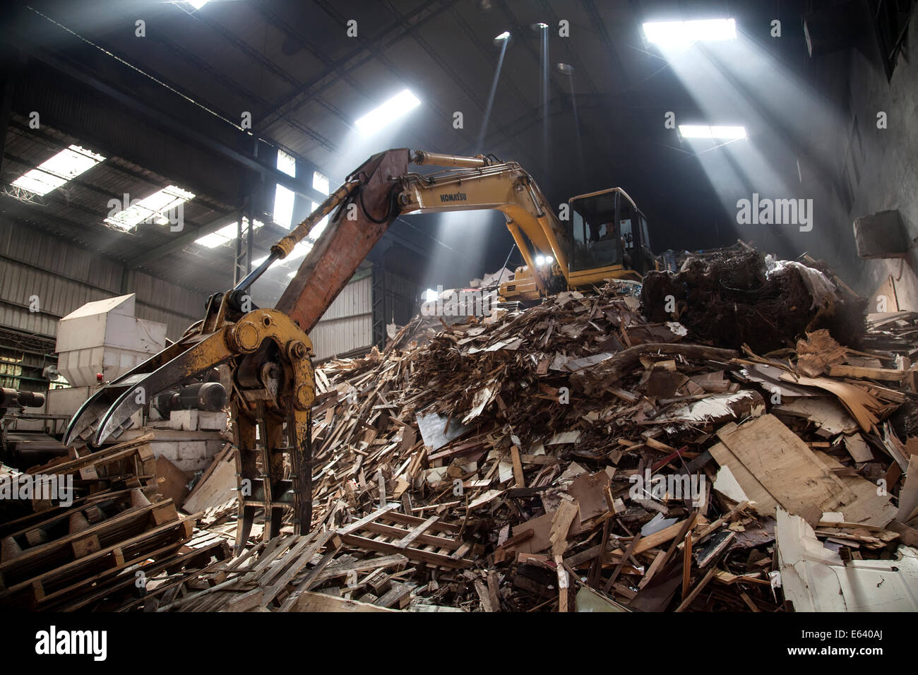 Heavy duty machinery used for dealing with a pile of waste timber in a Taipei's wood recycling factory. On July 27, 2014 in Taipei, Taiwan. (CTK Photo/Karel Picha) Stock Photo