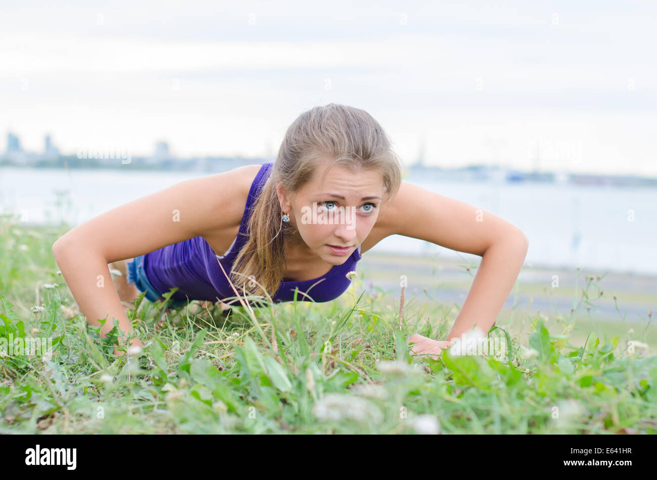 Pretty woman doing push-ups in the park Stock Photo - Alamy