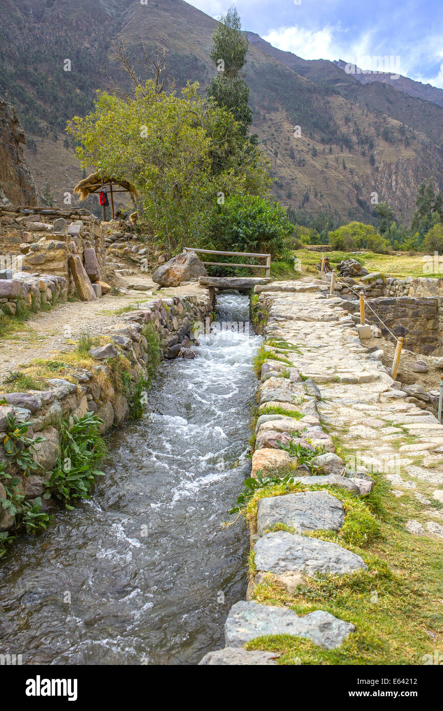 AncientInca domestic water supply at the old Inca ruins in Ollantaytambo in Peru Stock Photo