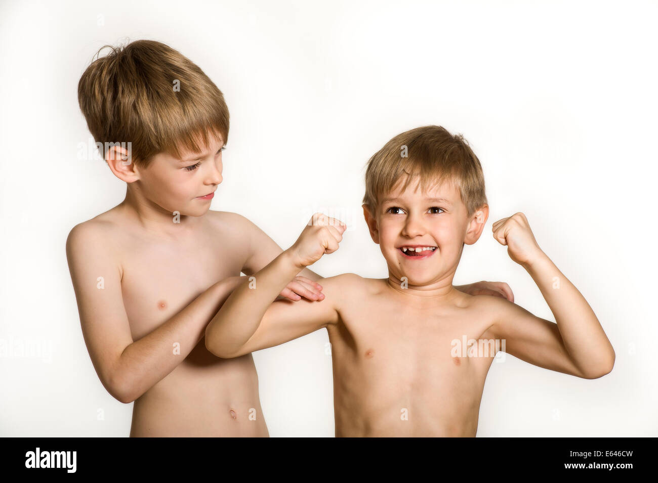Small Half Naked Brothers Posing On White Background Stock Photo