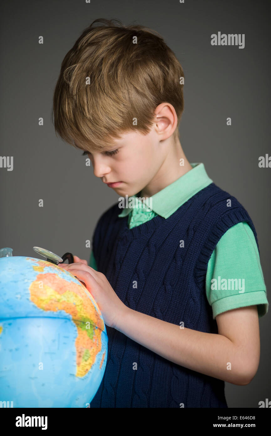 blond school boy with globe Stock Photo