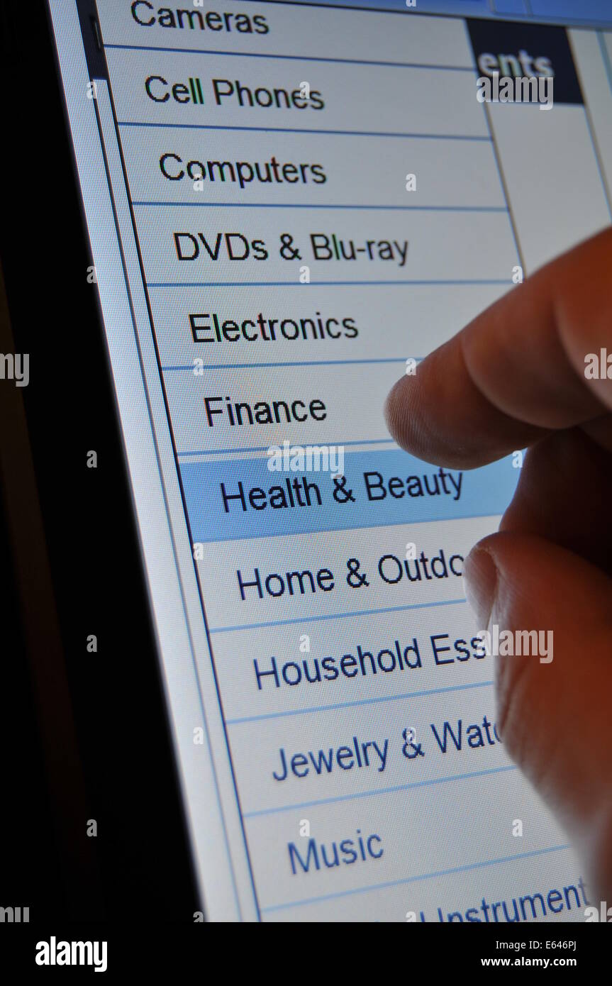 Hand and various products on electronic touchscreen Stock Photo - Alamy