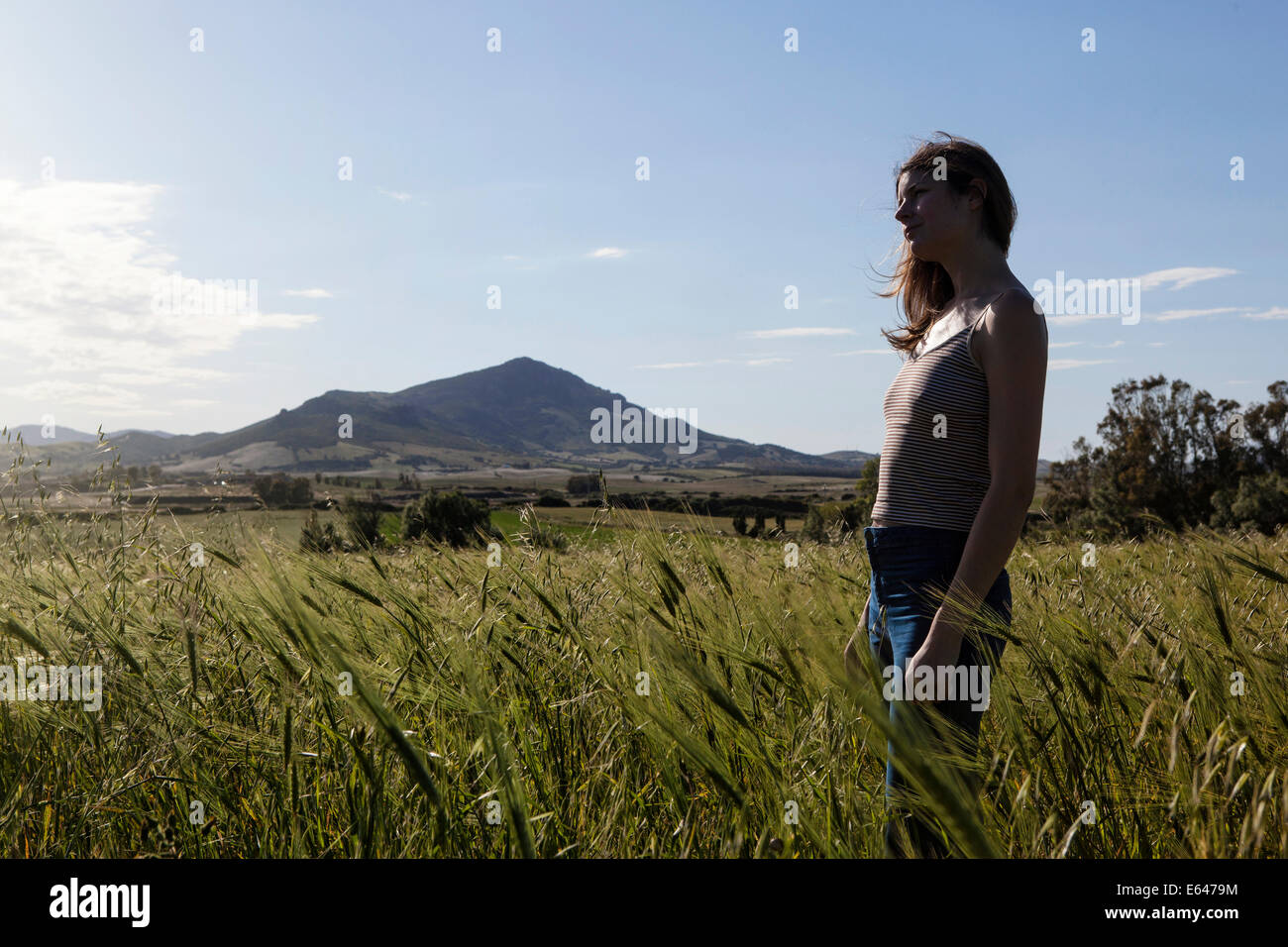 A young woman standing in a field Stock Photo - Alamy