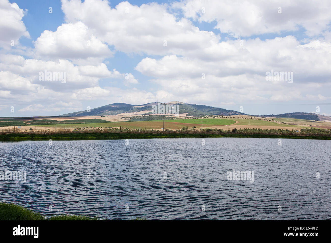 A rain water reservoir collects the surface flow during the rainy season. The water is then used in the dry season for irrigatio Stock Photo