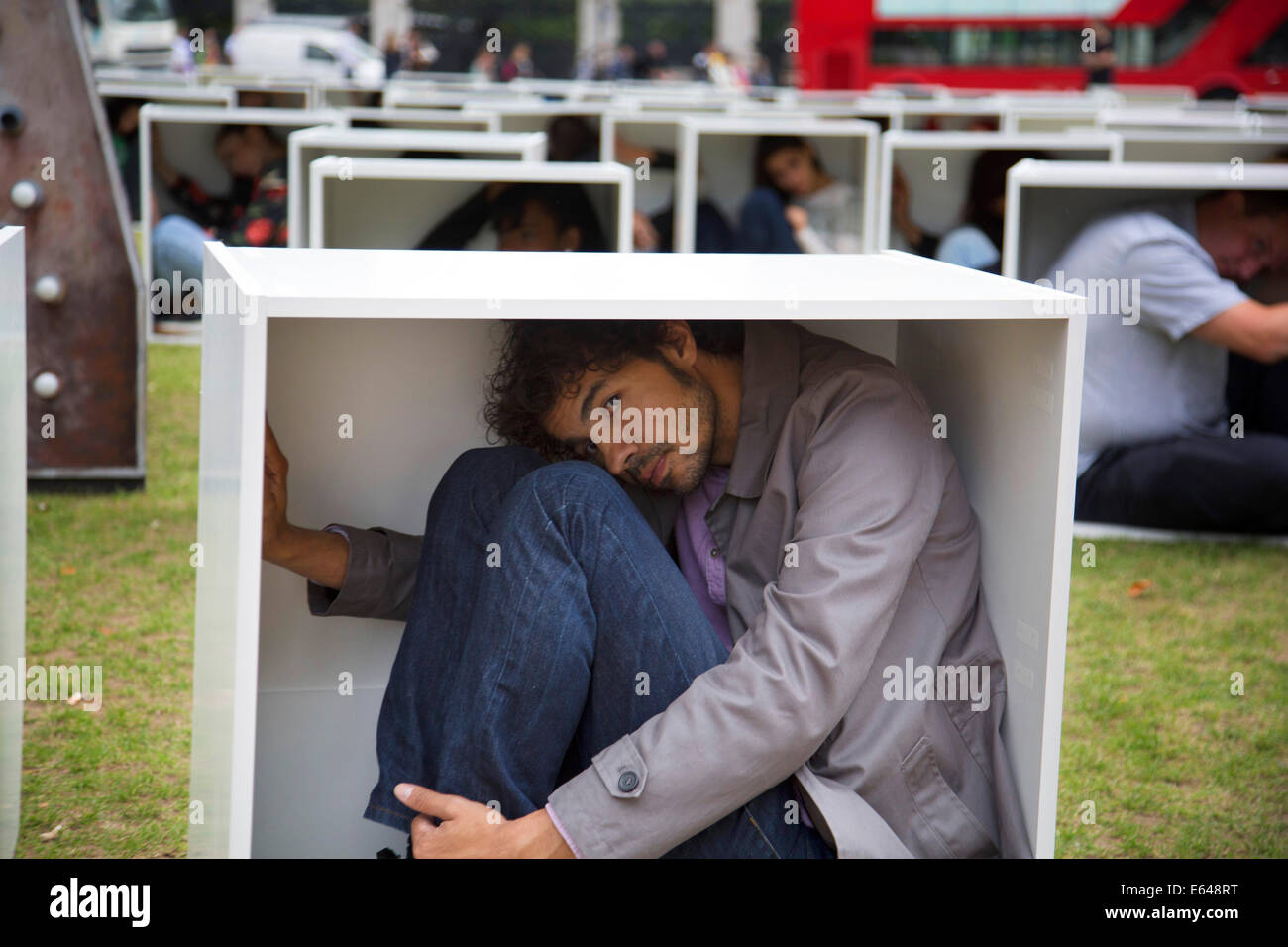London, UK, Thursday 14th August 2014. In Parliament Square, 150 men, women and children are squashed inside boxes for an Oxfam stunt to illustrate the conditions faced by the people in Gaza who are trapped by the blockade. Credit:  Michael Kemp/Alamy Live News Stock Photo