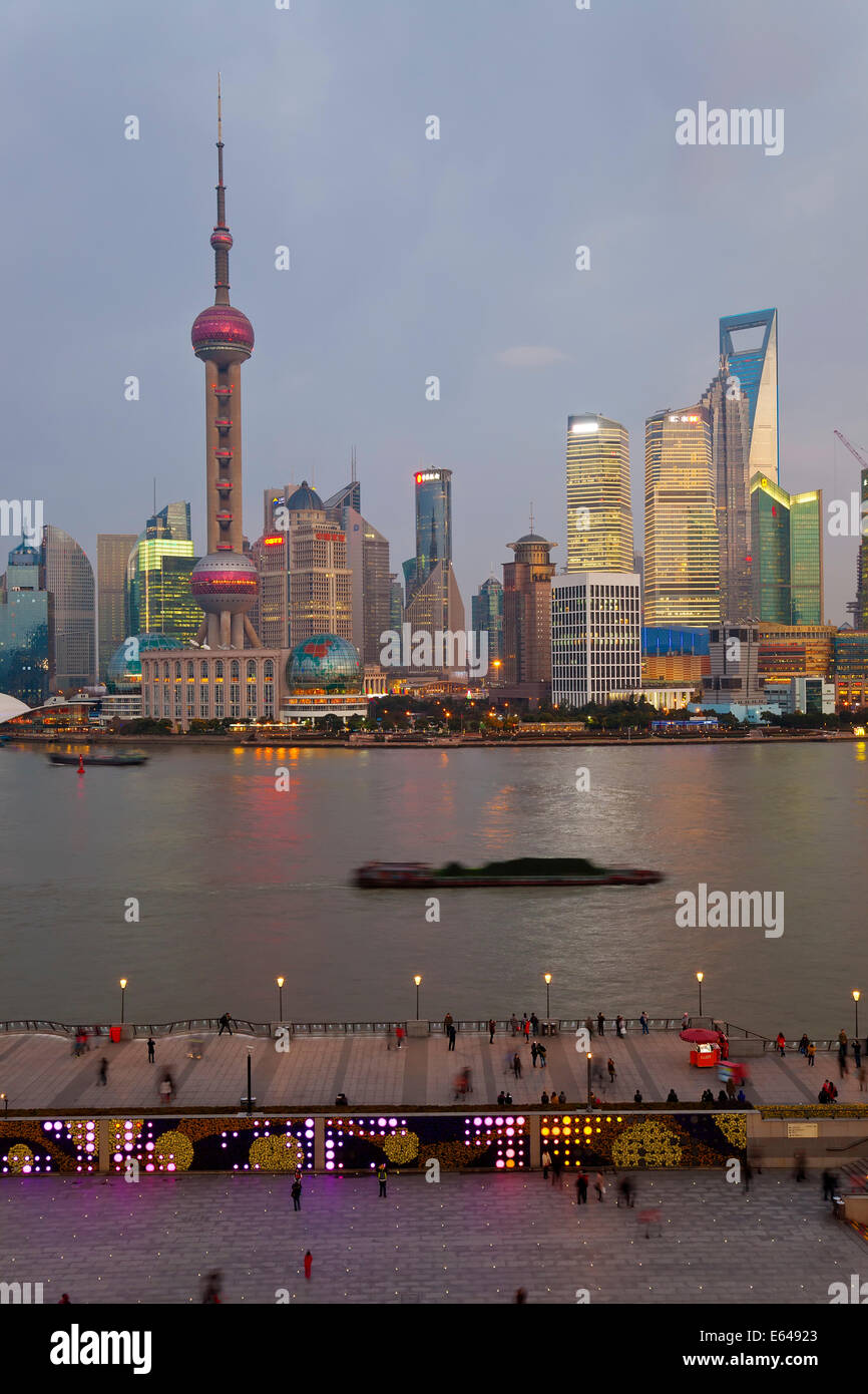 Barges and Pudong skyline at dusk, Shanghai, China Stock Photo