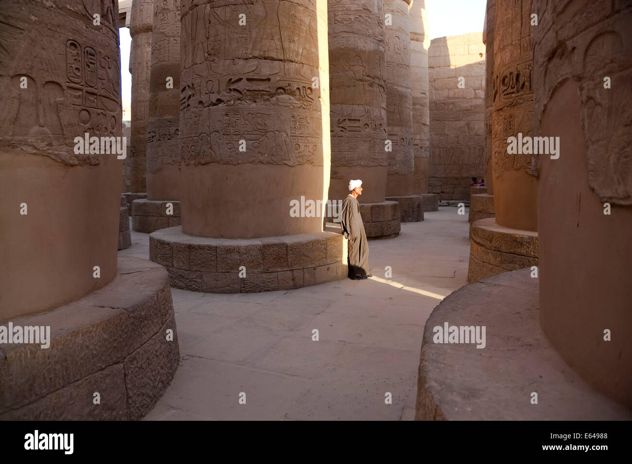 Egypt, Luxor, Karnak, The Great Temple of Amun, Great Hypostyle Hall. Man in traditional dress. Stock Photo