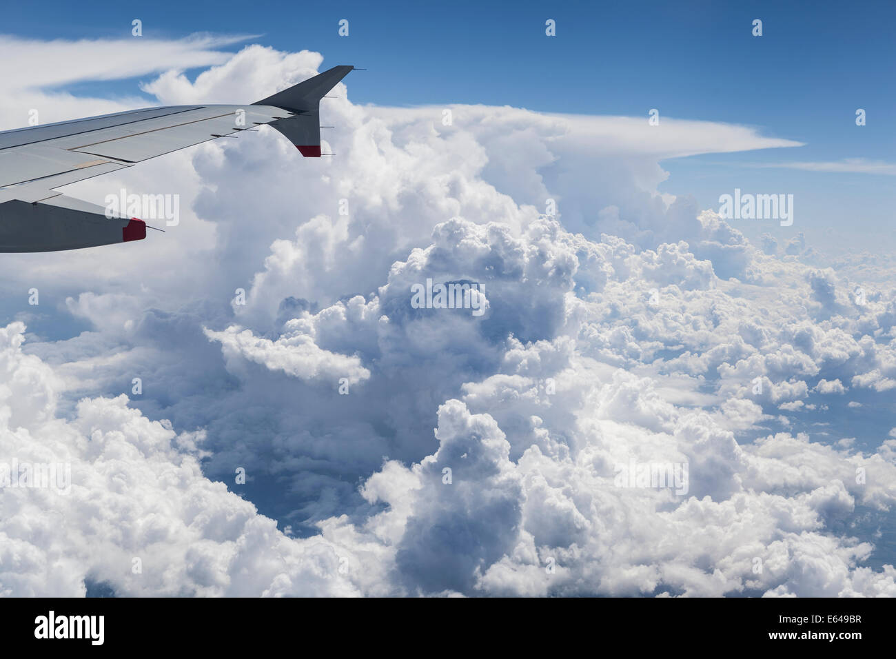 Wing plane above cloud formation Stock Photo
