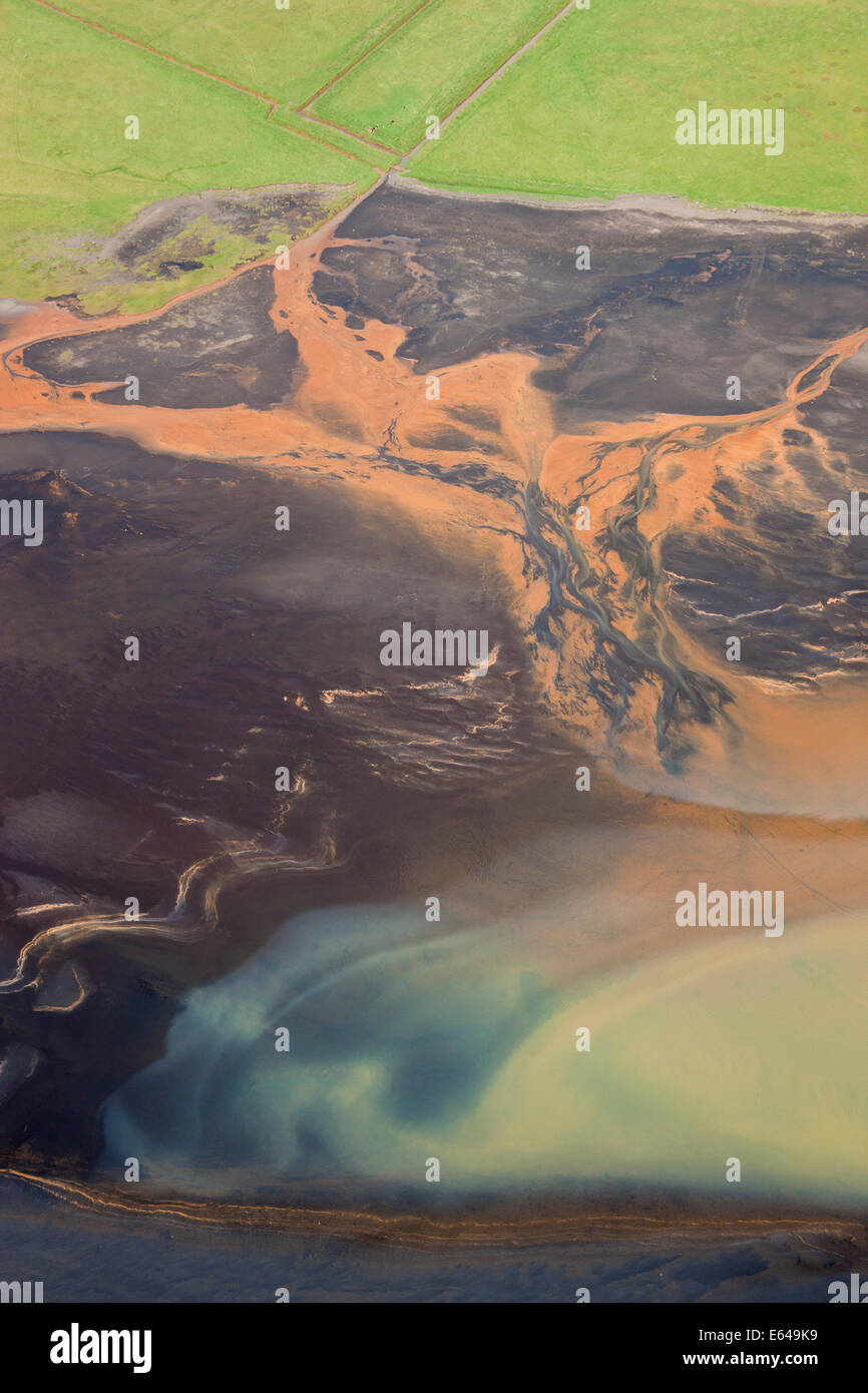 Aerial view of river estuary or delta, coloured by sewerage outlet, nr Hvammur, SW Iceland Stock Photo