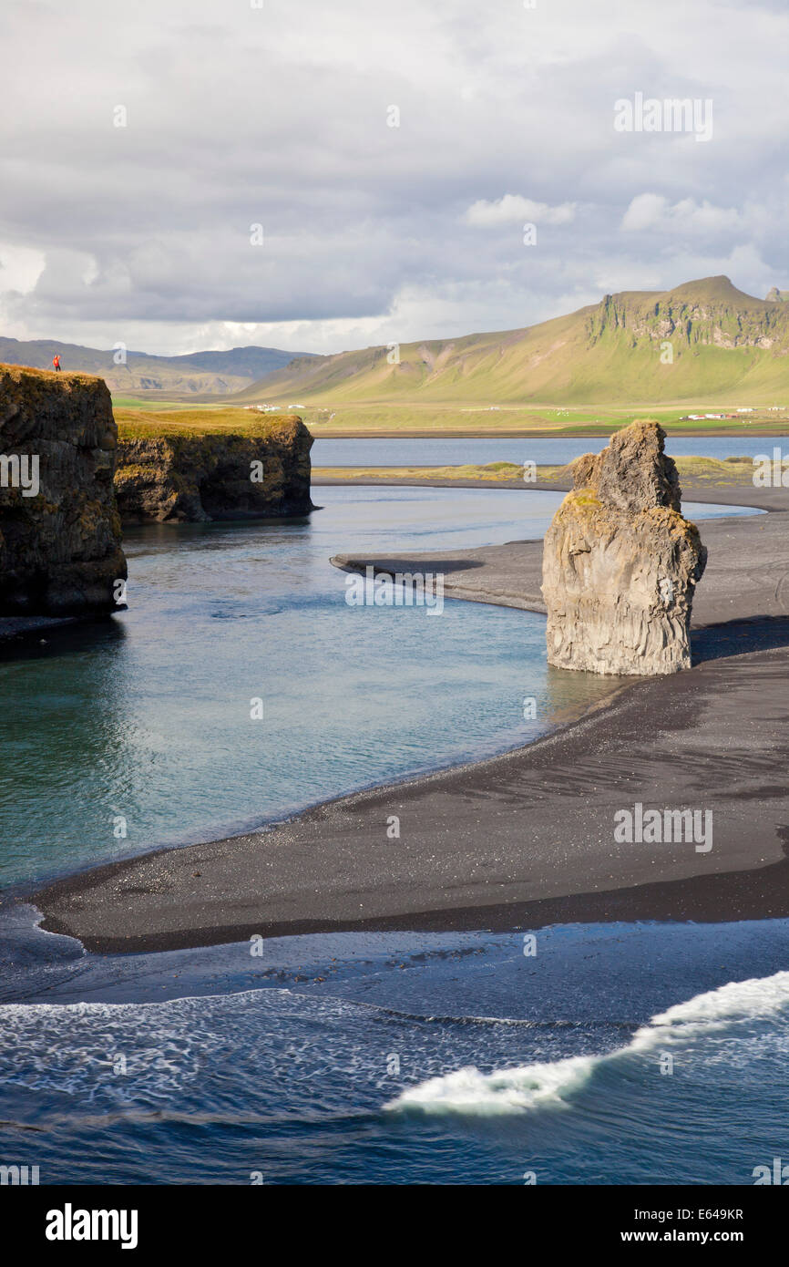 Woman standing on cliff, Reynisdrangar cliffs, Dyrholaey, Iceland Stock Photo