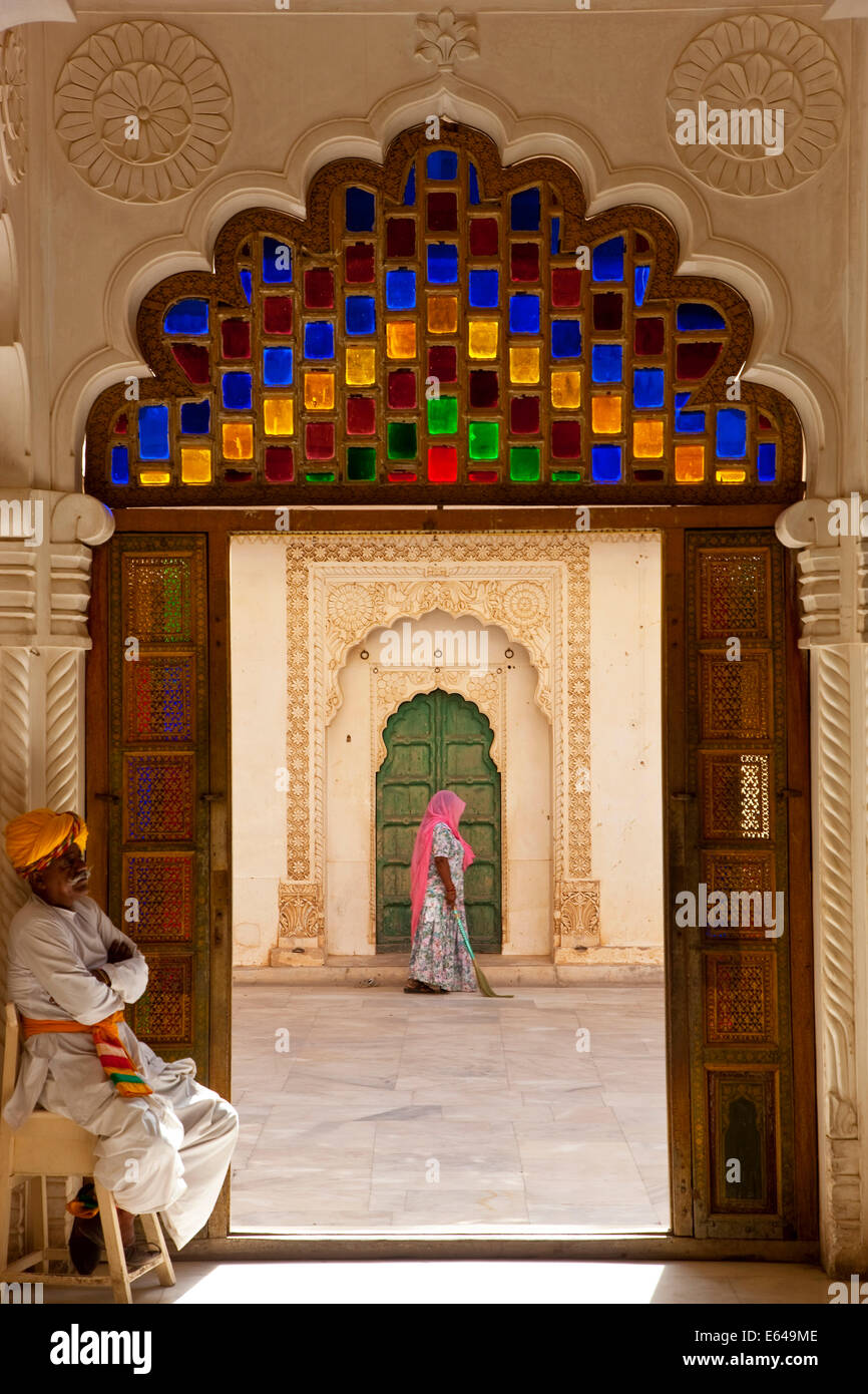 View through doorway of woman sweeping, Meherangarh Fort, Jodhpur, Rajasthan, India Stock Photo