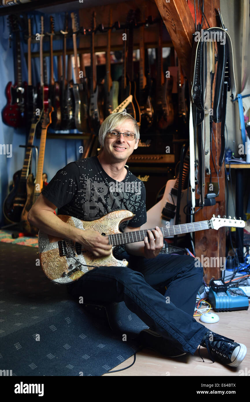 Berlin, Germany. 08th Aug, 2014. EXCLUSIVE - Music producer, guitar designer and owner of MSP guitars, Martin Schlechta, poses in his music studio in Berlin, Germany, 08 August 2014. He designs unusual electric guitars, which use his own design for pick-ups and other electronics that give them a special sound. He designs all of the guitars individually with special surfaces made from leather, rhinestones or brass inlays. He cooperates with Sido, Marcia Barrett and Jennifer Rush. Photo: JENS KALAENE/dpa/Alamy Live News Stock Photo