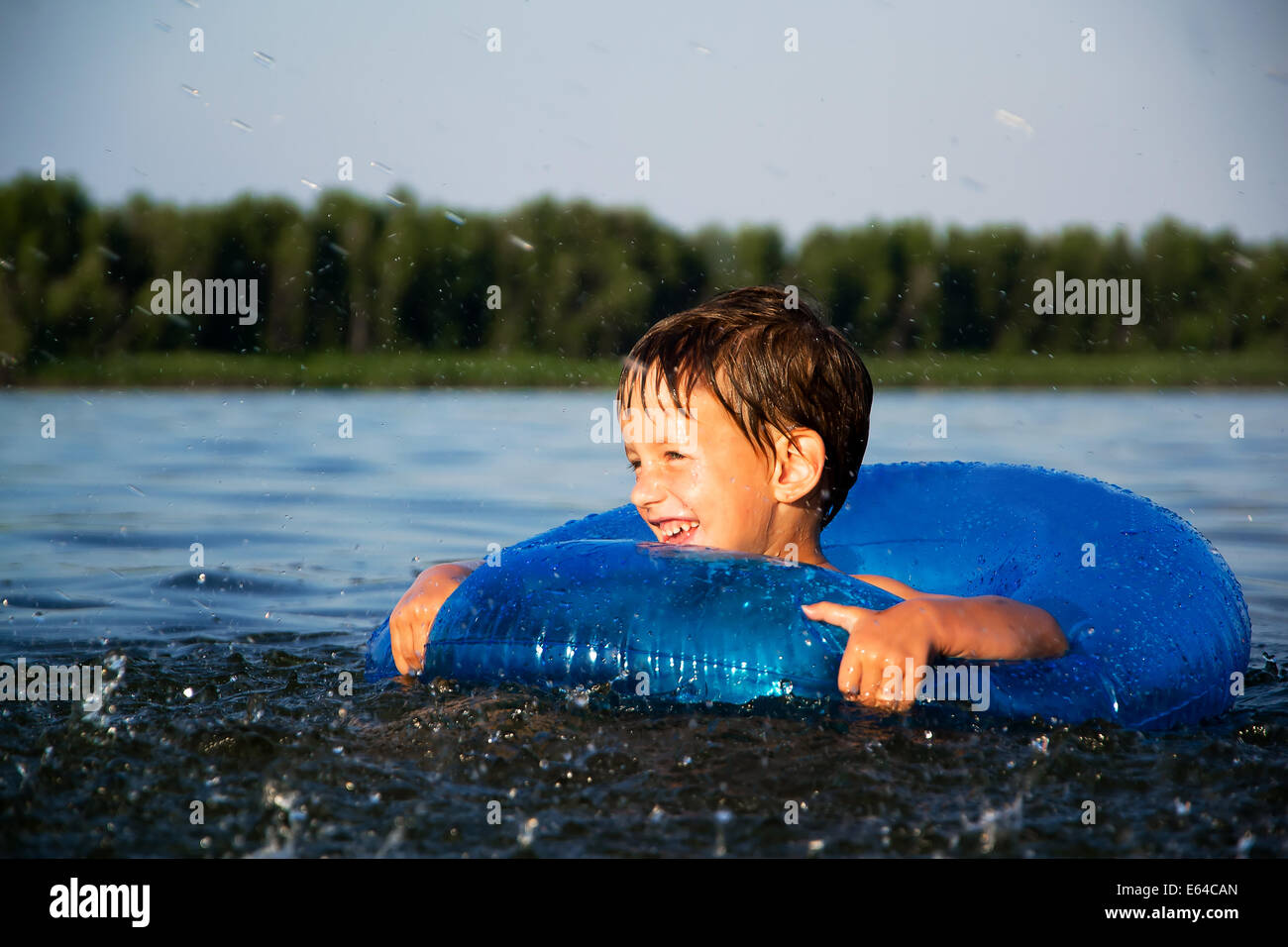 Boy relaxing on water tube Stock Photo Alamy