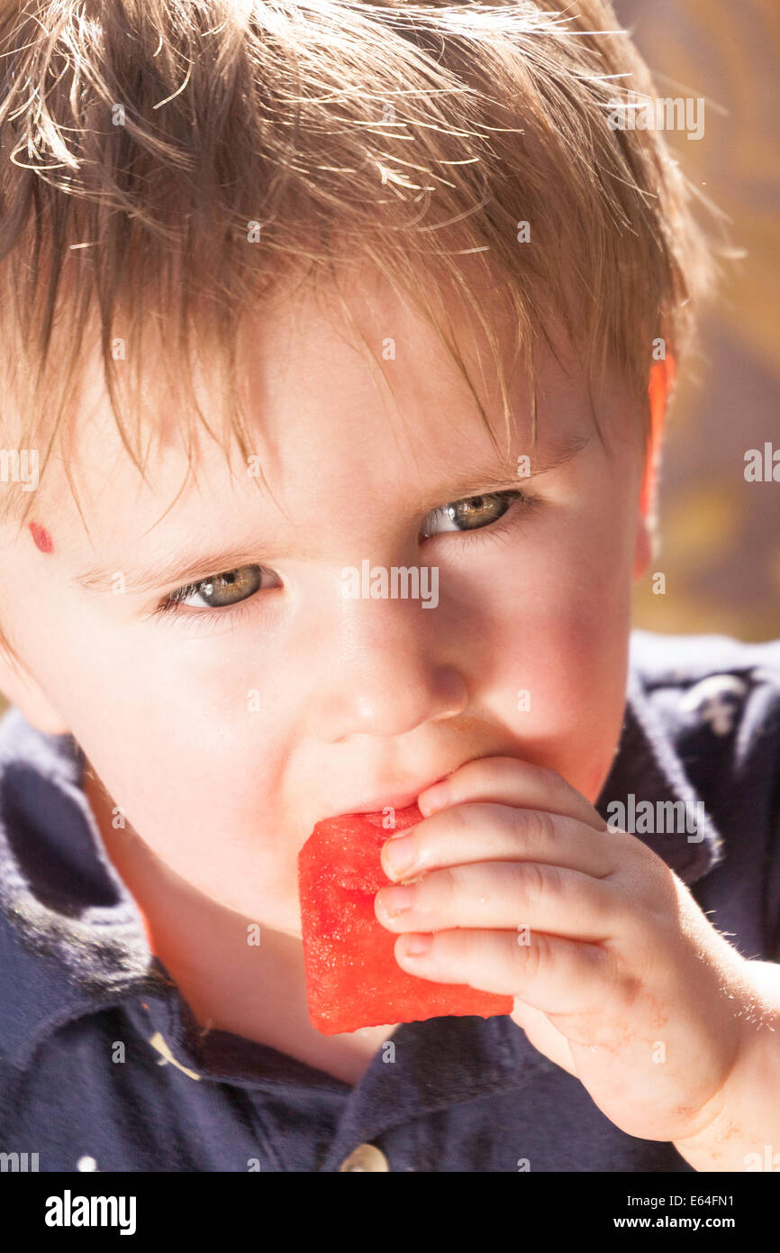 Toddler Looking at Camera Holding Watermelon, USA Stock Photo