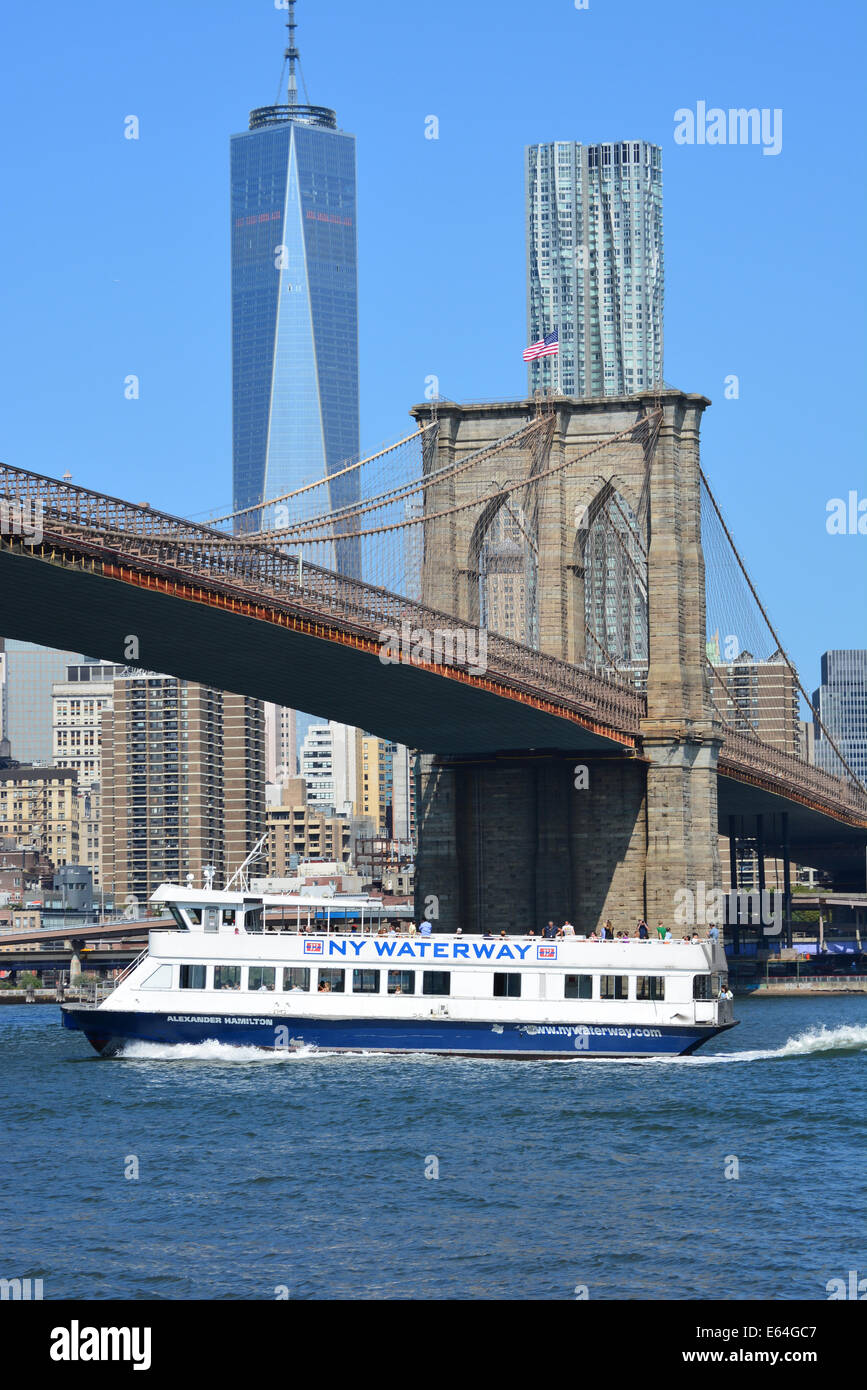 New York ferry passing under the Brooklyn Bridge as it cruises along