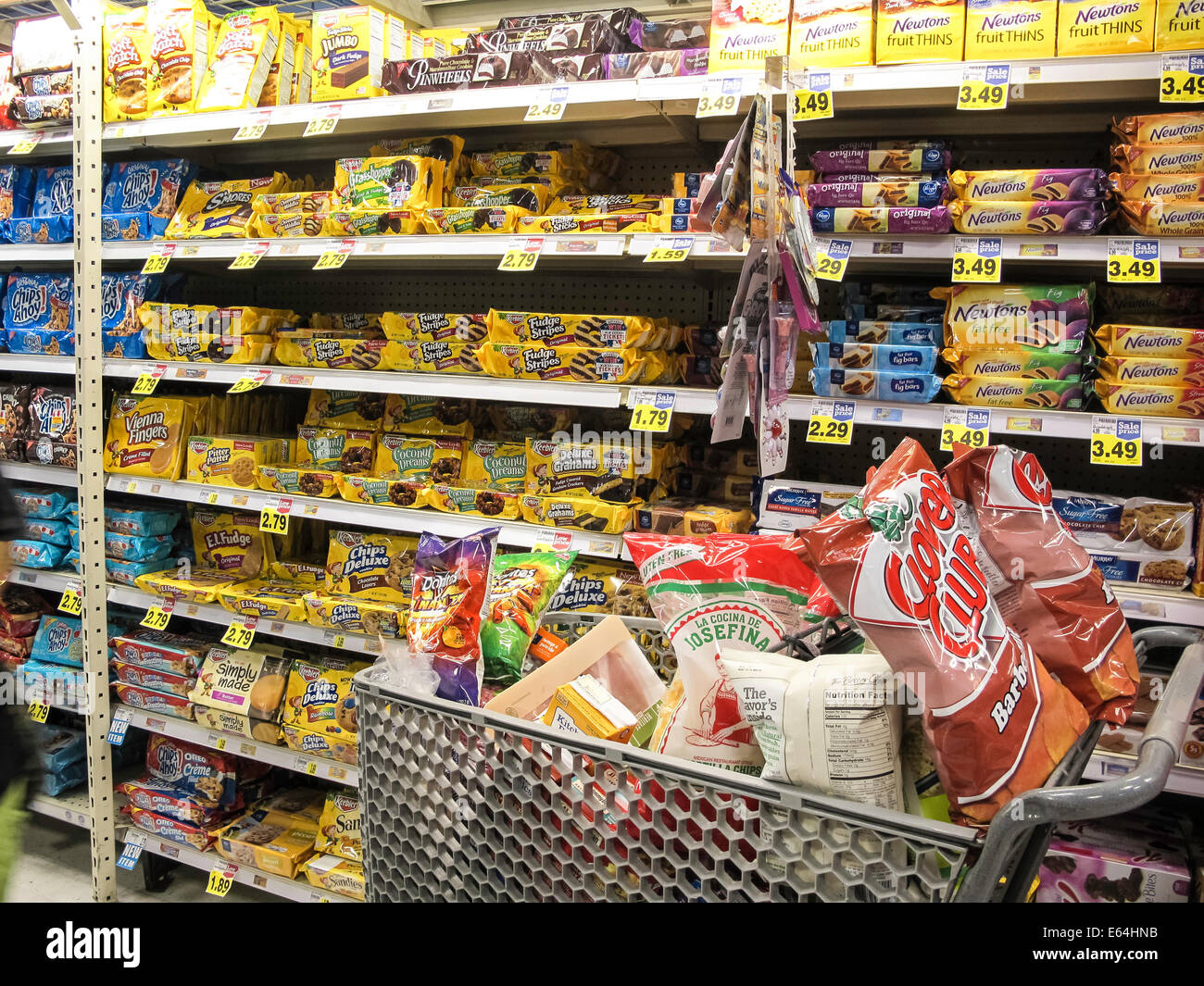 Filled Grocery Cart in Snack and Cookie  Aisle, Smith's Grocery Store, Great Falls, Montana, USA Stock Photo