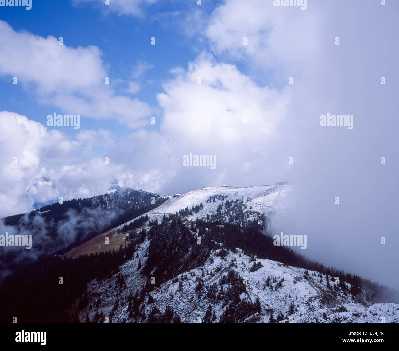 Cloud  mist and snow  on The Schmittenhohe & surrounding mountains  above Zell am See  Salzburgerland Austria Stock Photo