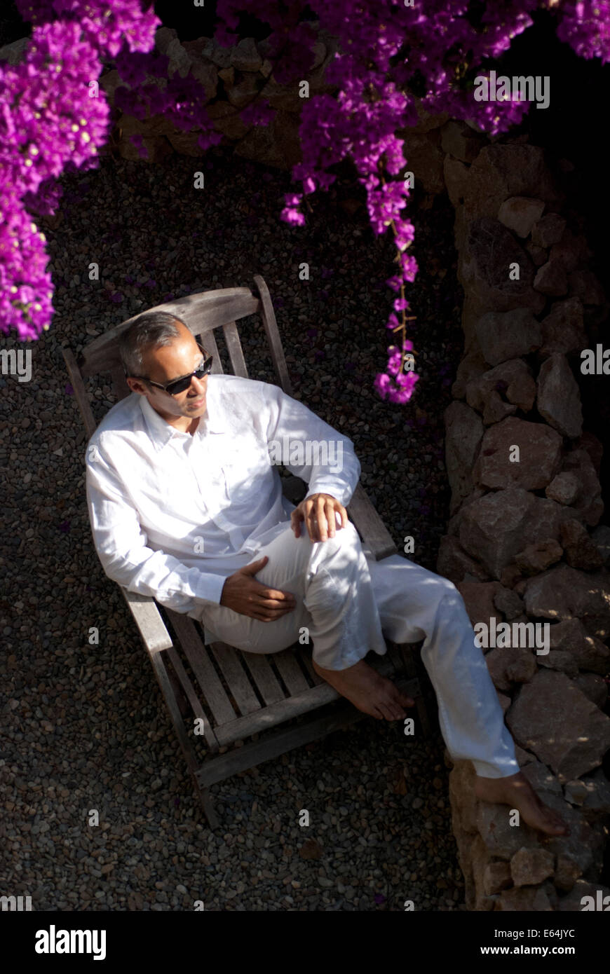mature man sitting in the garden Stock Photo
