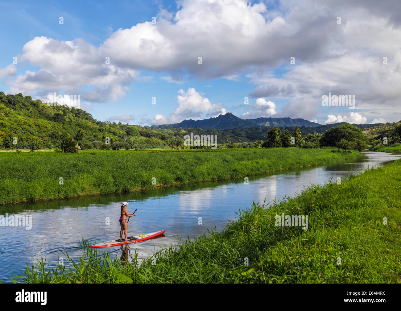 Woman on SUP  in  the Hanalei River on Kauai Stock Photo