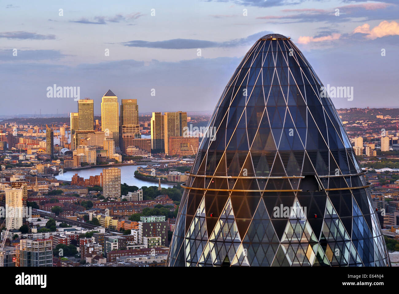 General view of buildings of the city skyline, Canary Wharf and the Gherkin, 30 St Mary Axe at dusk in London, England Stock Photo