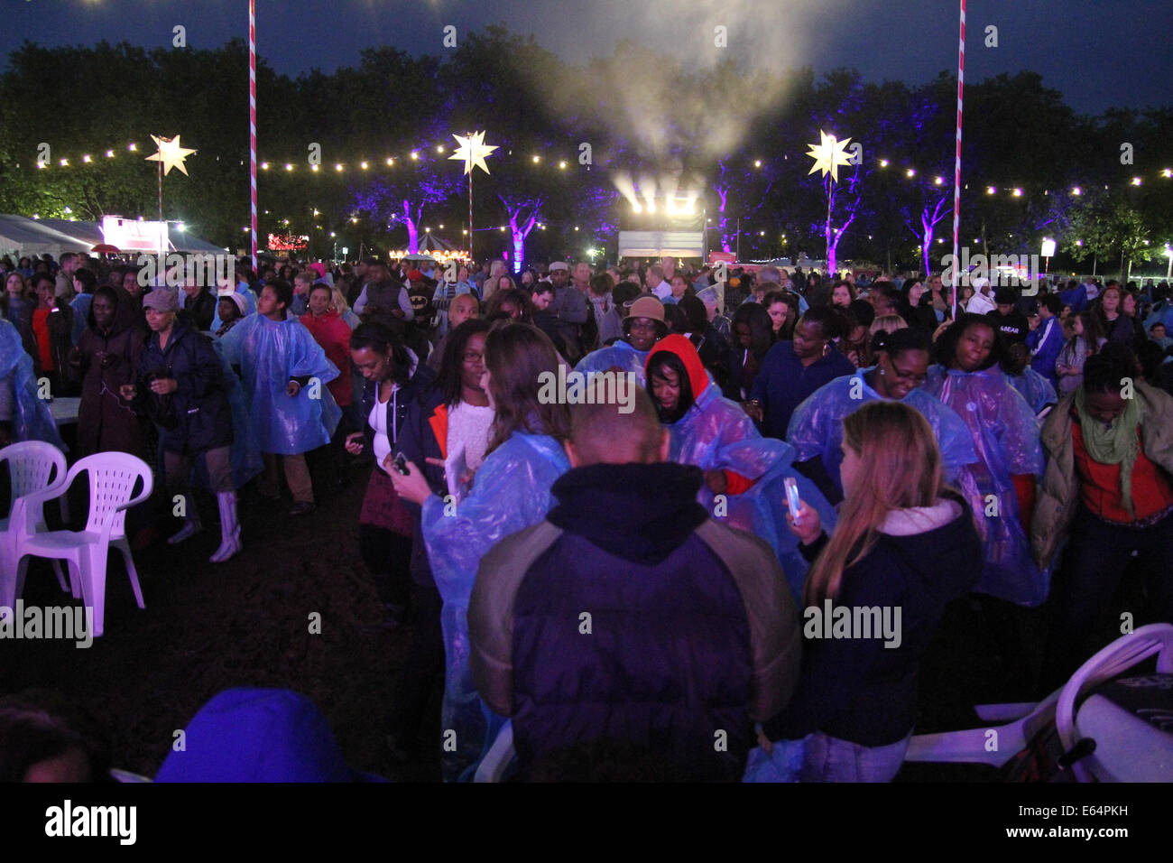 Hundreds of Newham residents who braved  the wet weather to dance to disco tunes at Central Park. Credit: David Mbiyu/ Alamy Live News Stock Photo