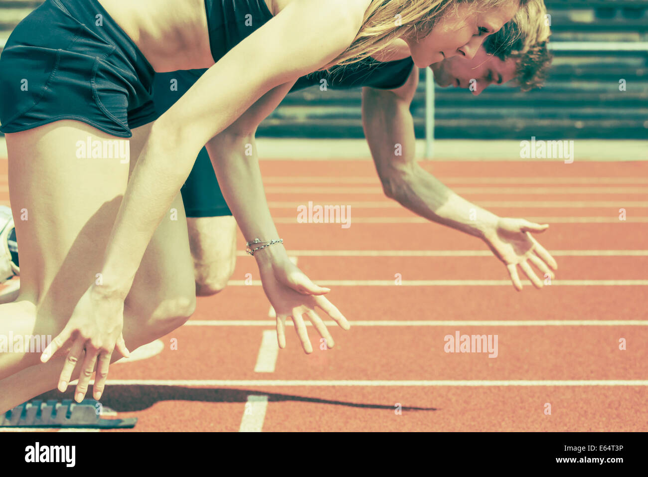 Race of male and female track and field athletes in a stadium. Vintage