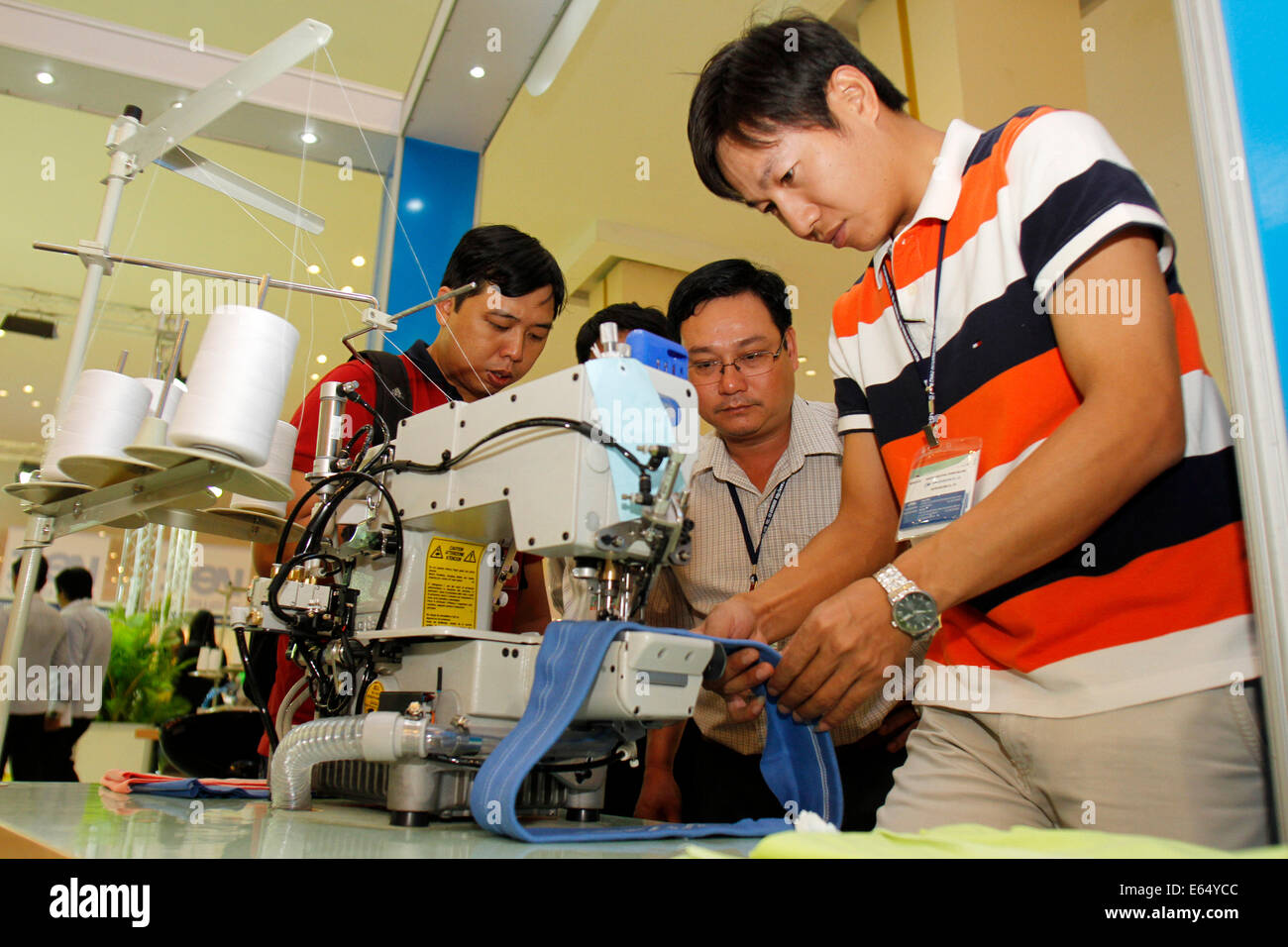 Phnom Penh, Cambodia. 15th Aug, 2014. A man tests a sewing machine