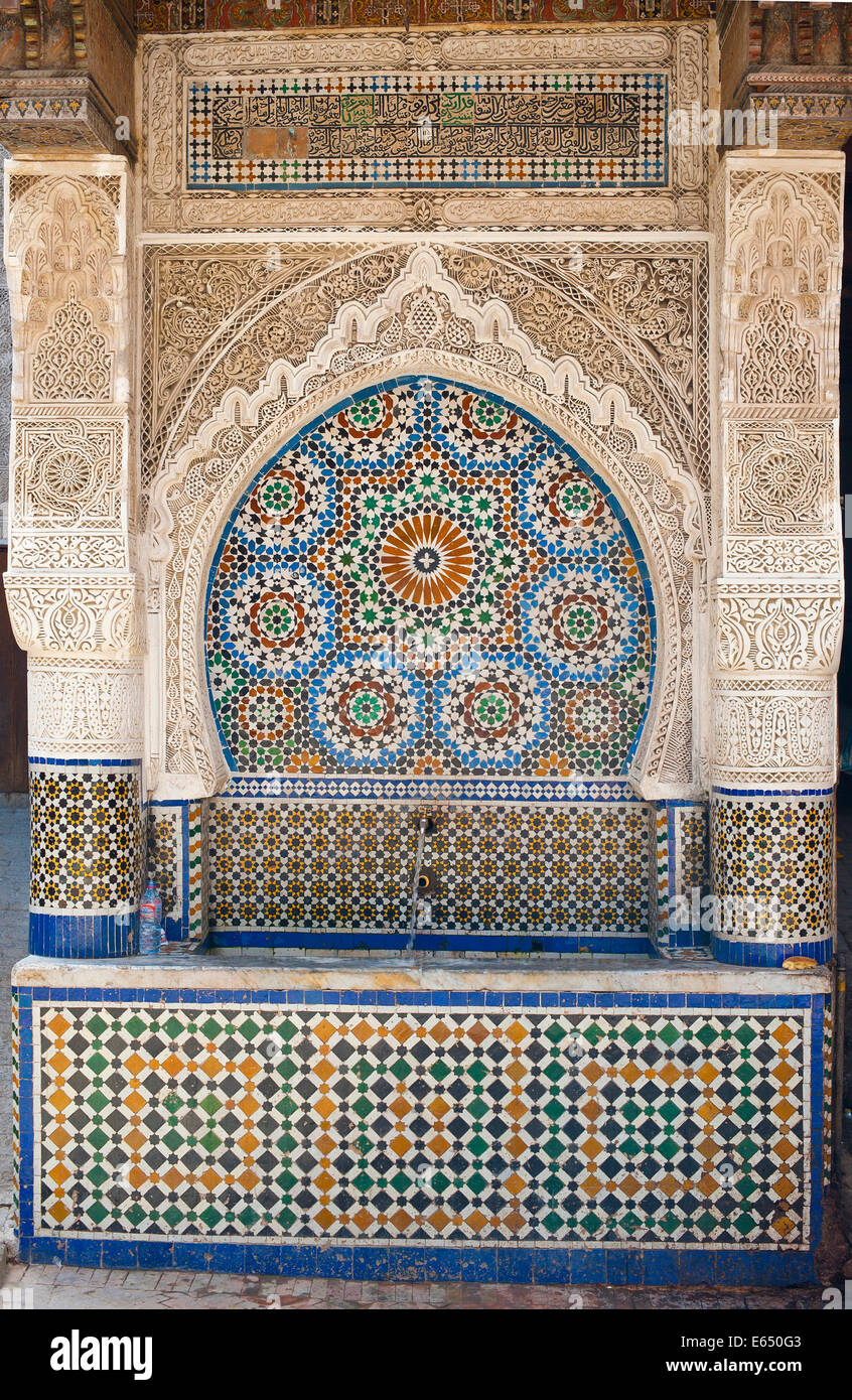 Traditional water fountain with mosaics and stucco work, medina of Fes, Morocco Stock Photo