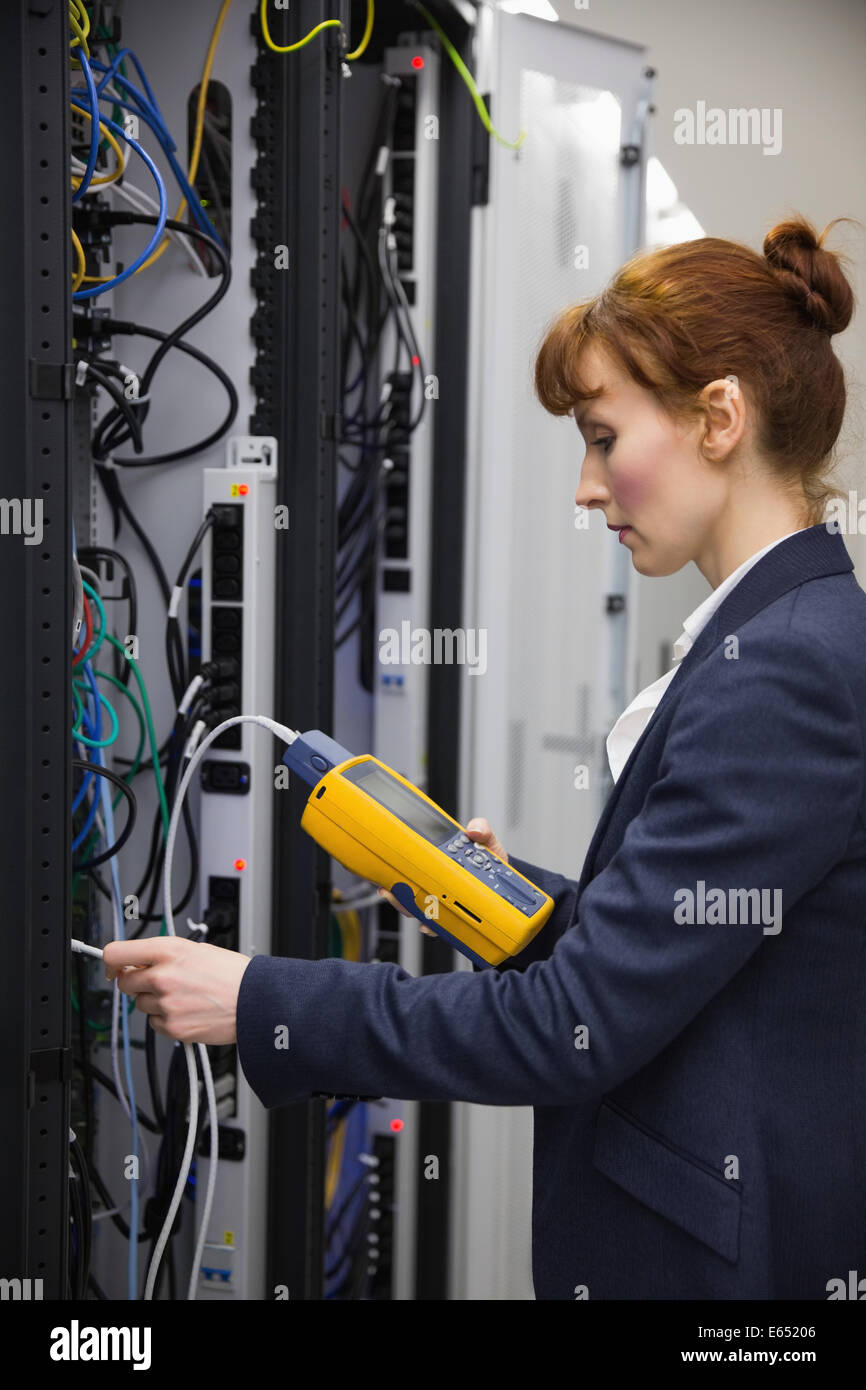 Technician using digital cable analyzer on server Stock Photo - Alamy