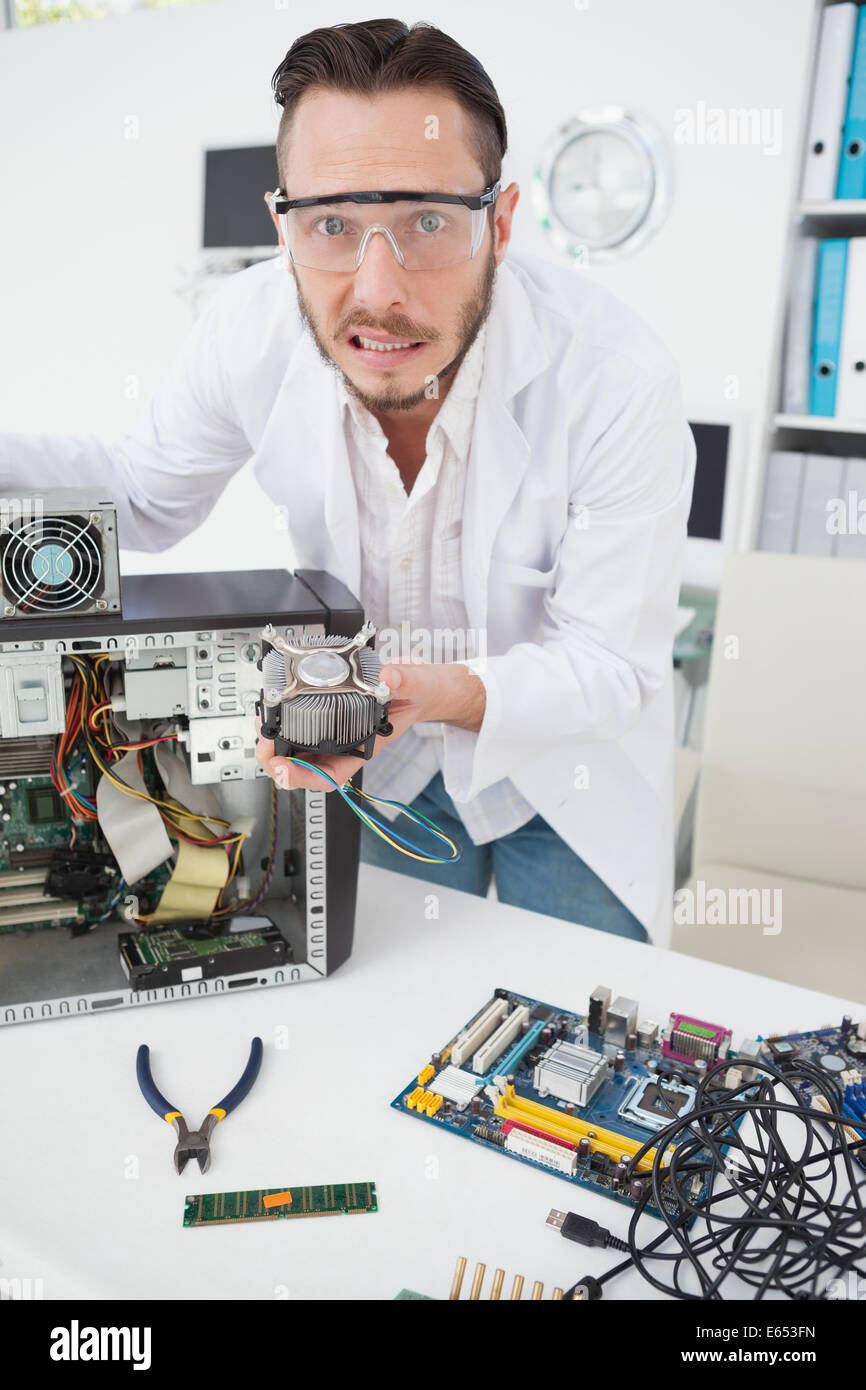 Stressed computer engineer showing broken fan Stock Photo Alamy