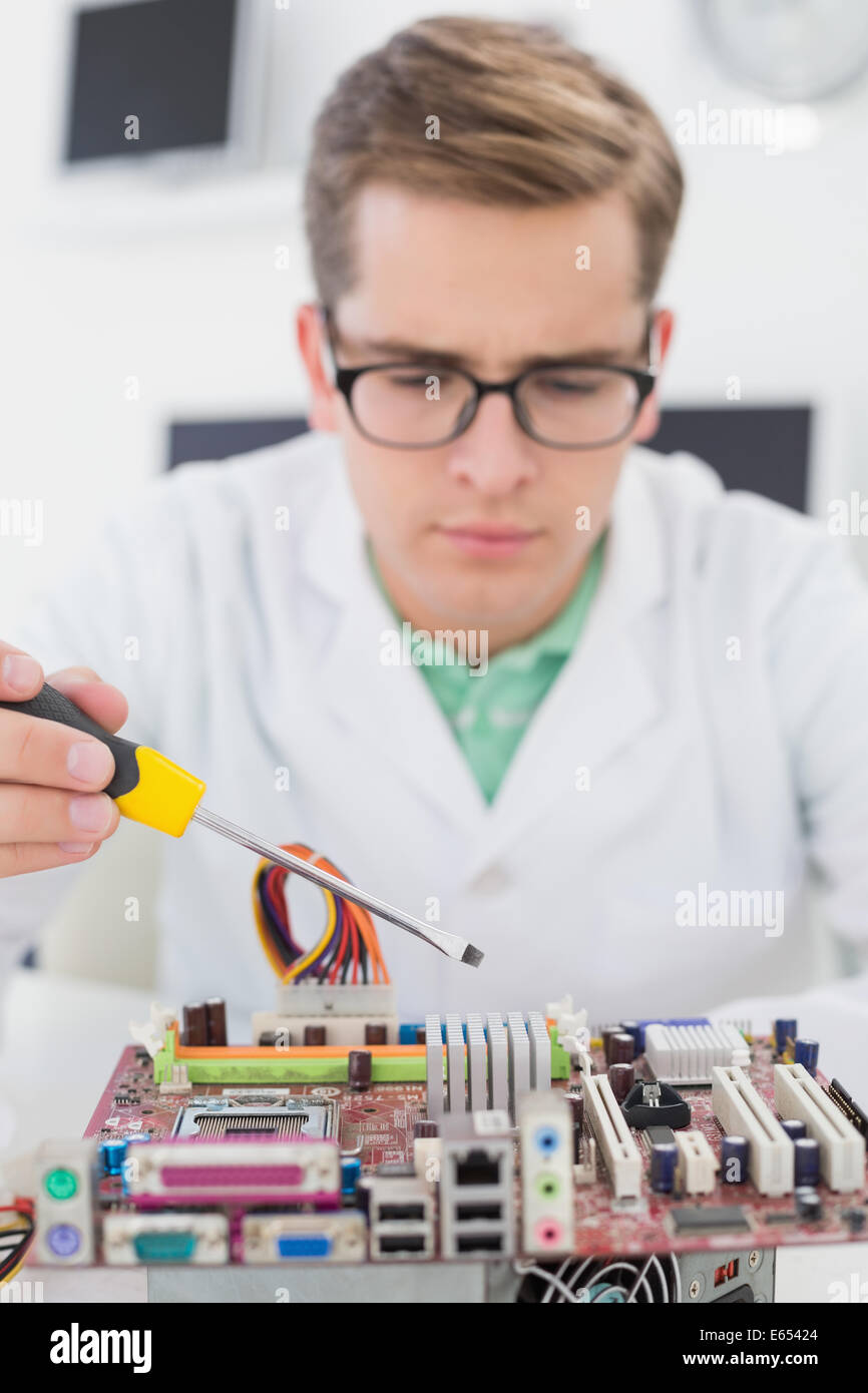 Technician working on broken cpu with screwdriver Stock Photo - Alamy