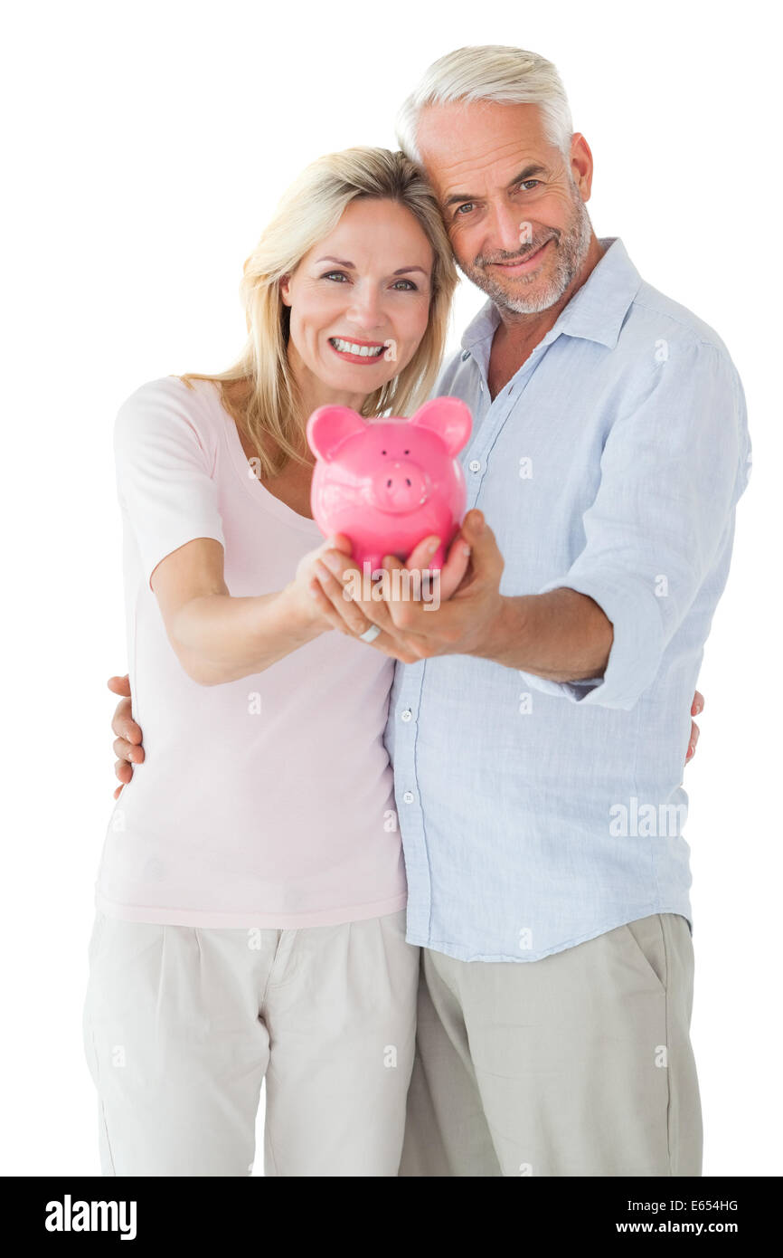 Happy couple showing their piggy bank Stock Photo - Alamy