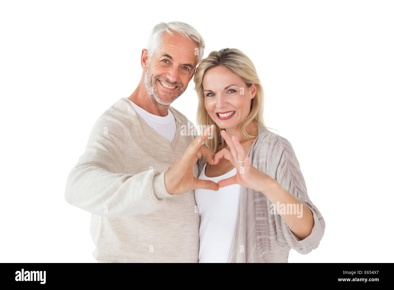 Happy couple forming heart shape with hands Stock Photo - Alamy