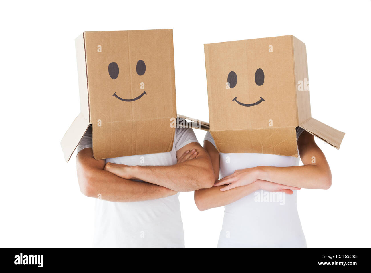 Couple wearing smiley face boxes on their heads Stock Photo Alamy