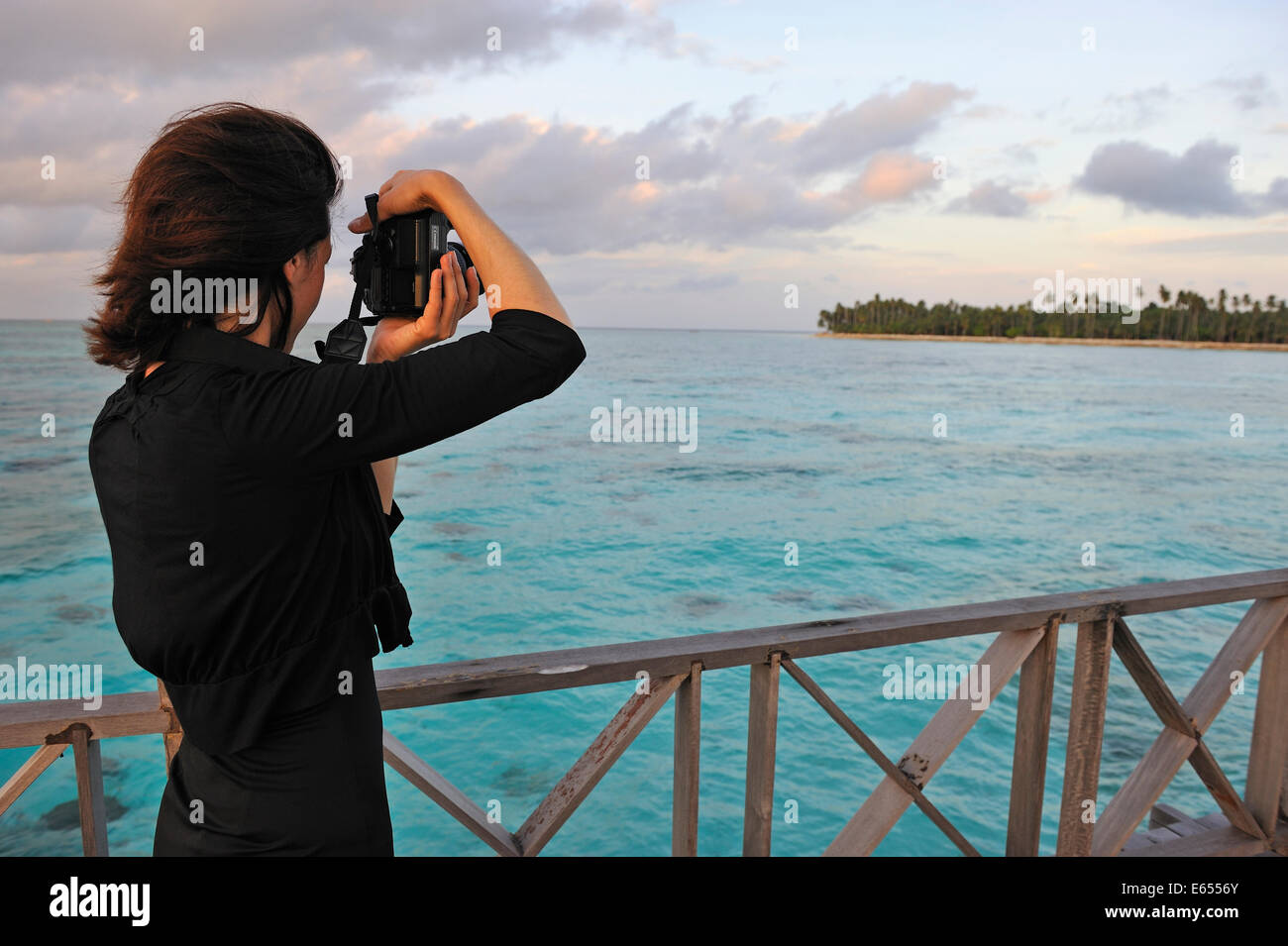 Woman taking a photograph of a tropical island, Borneo, Sabah State, Malaysia, Southeast Asia Stock Photo
