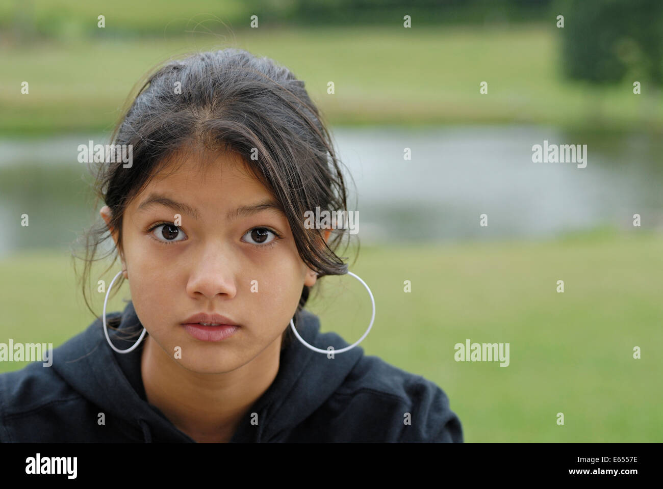 Young teenage Eurasian girl portrait outdoors Stock Photo