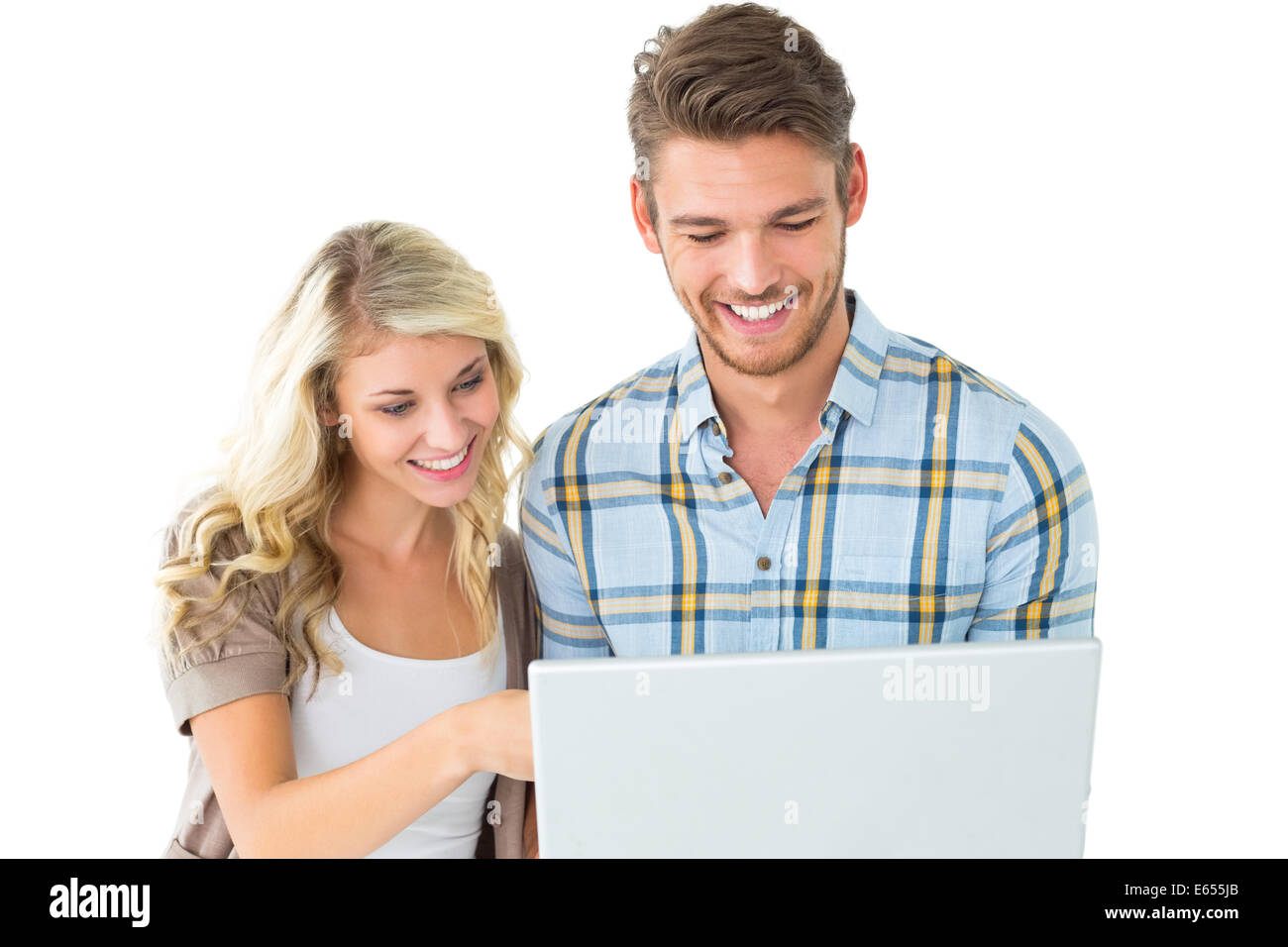 Attractive couple standing and using laptop Stock Photo - Alamy