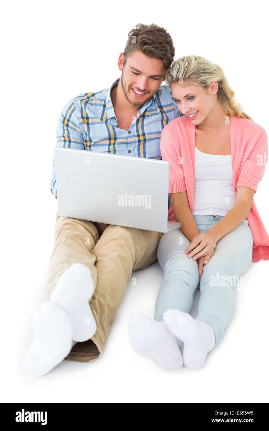 Attractive young couple sitting using laptop Stock Photo - Alamy