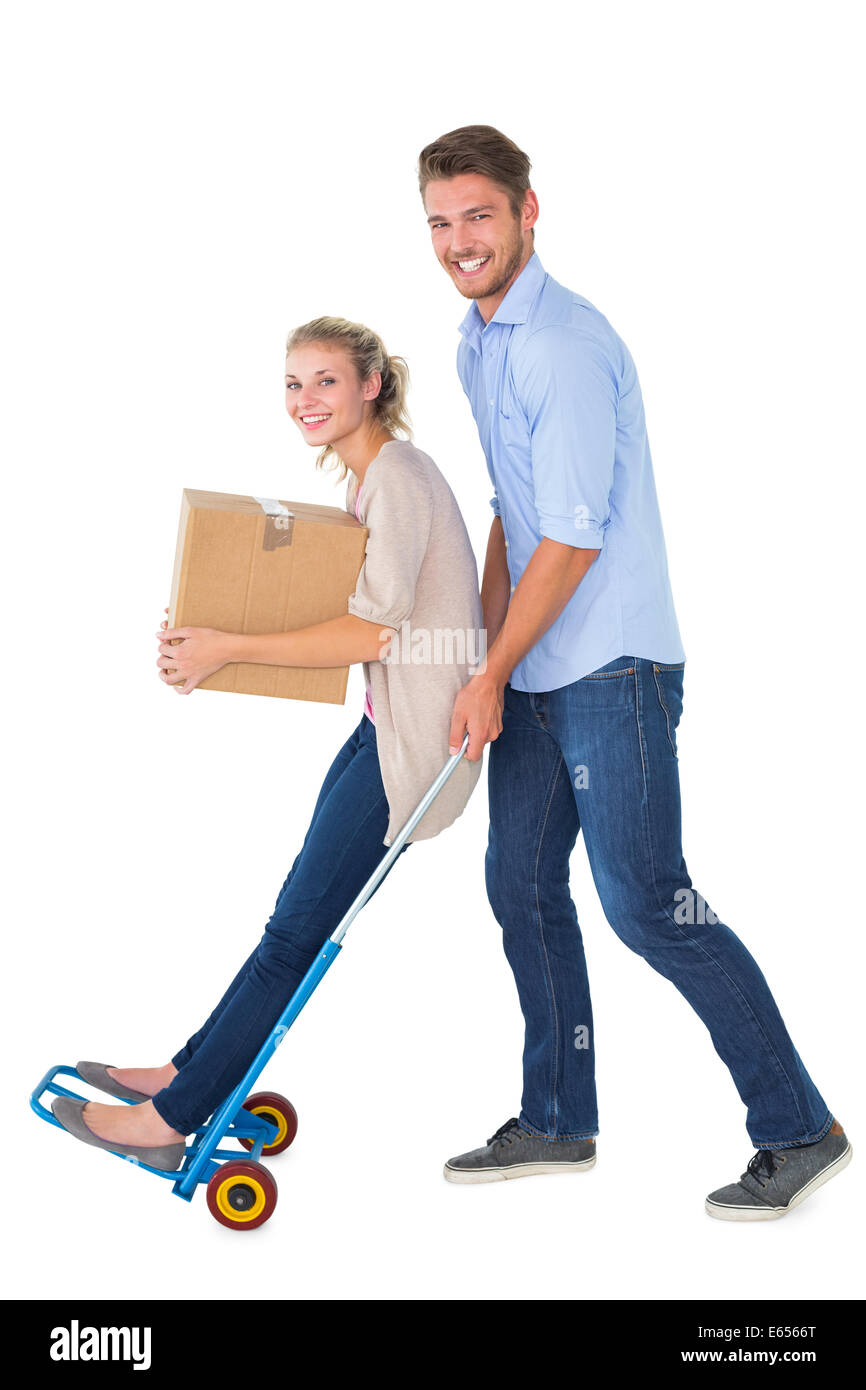 Young couple having fun on moving trolley Stock Photo - Alamy