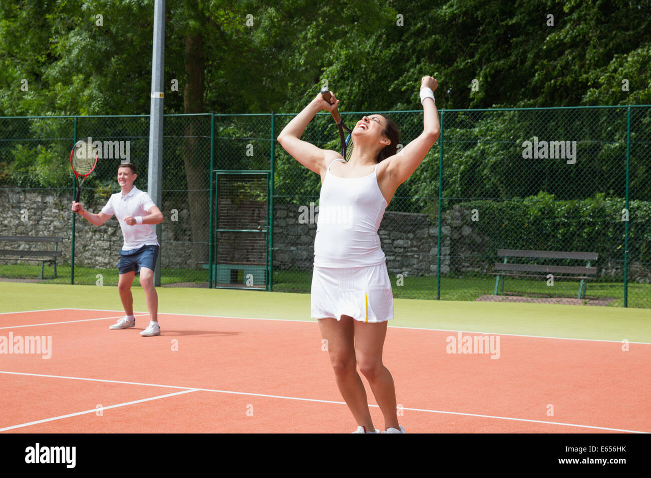 Tennis doubles team celebrating a win Stock Photo Alamy