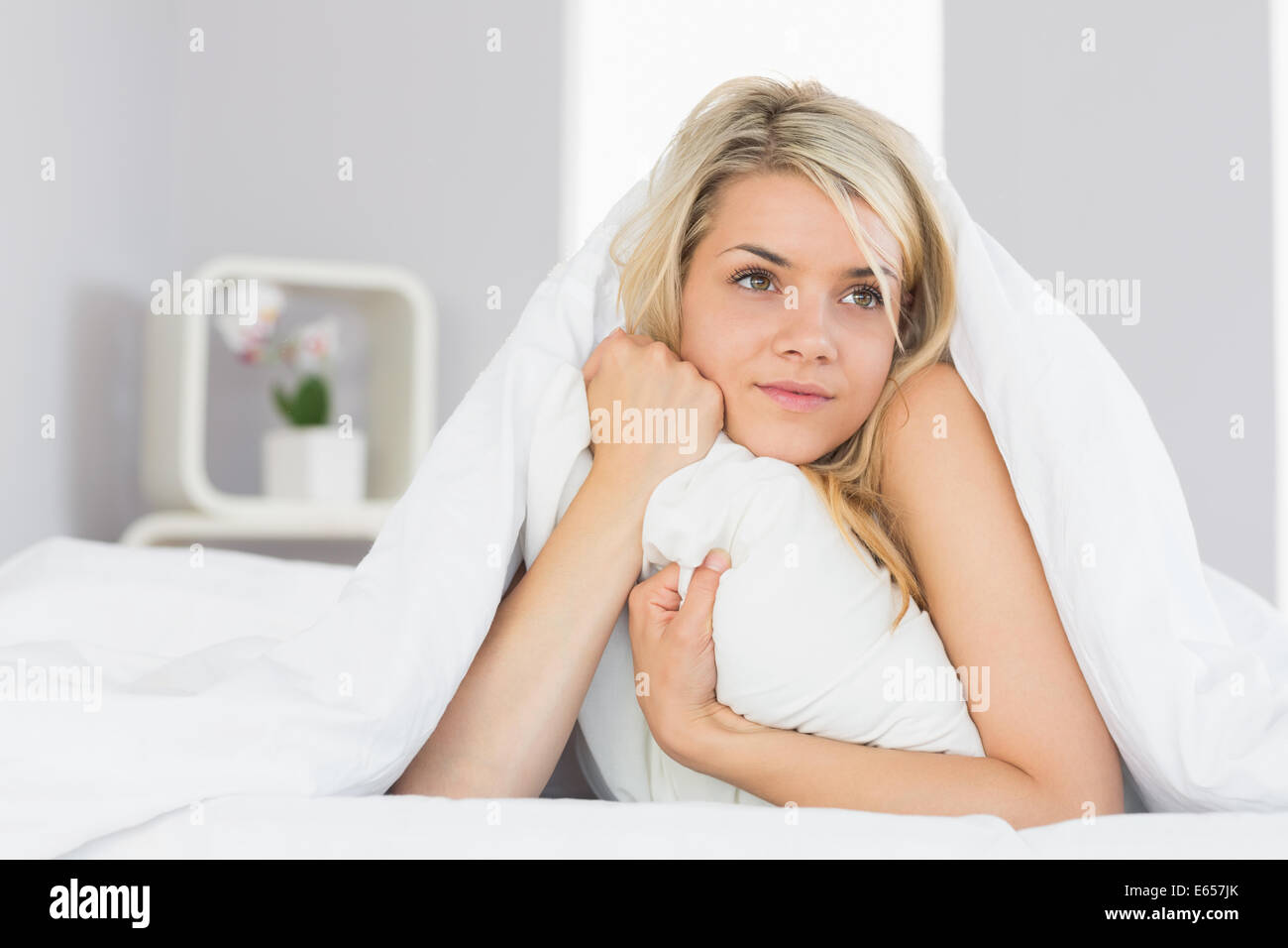 Thoughtful relaxed woman lying in bed Stock Photo Alamy