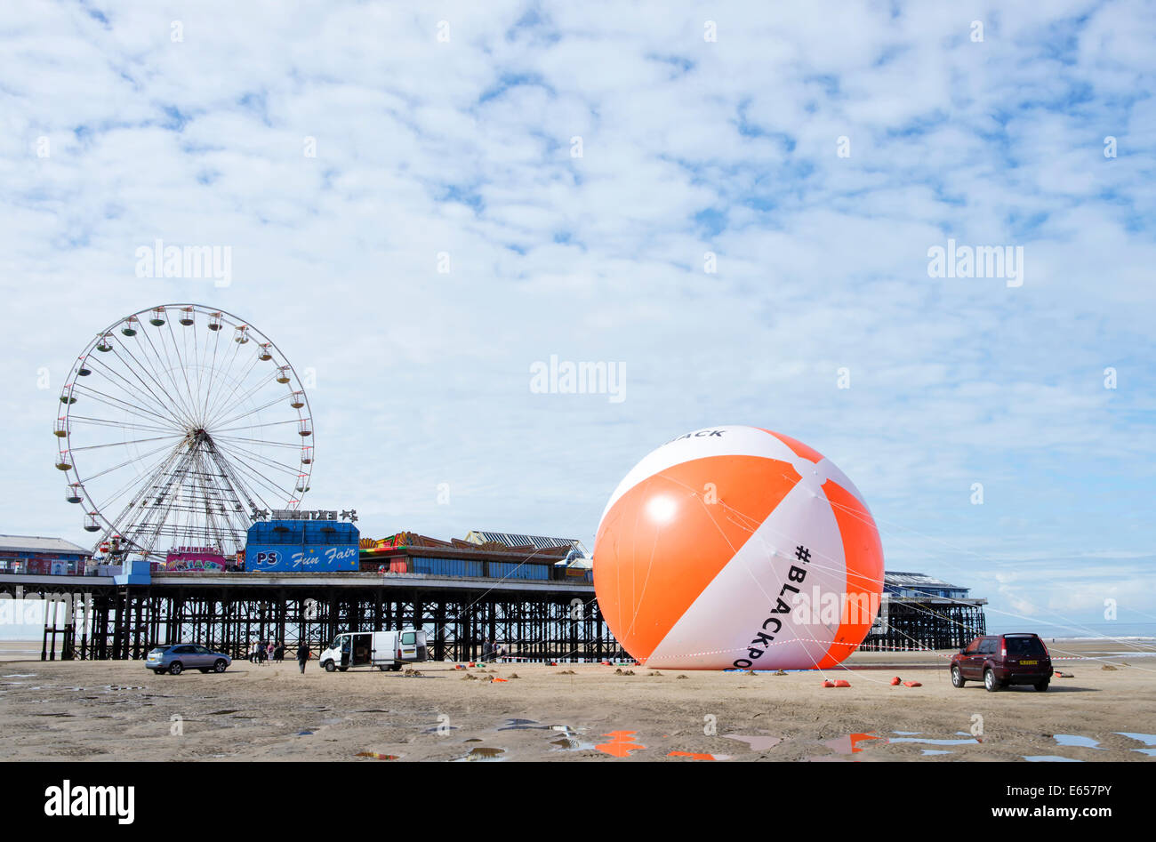 Blackpool now holds the Guiness World Record for the biggest beach ball in history. The seaside resort had it's achievement validated by Guiness World Records as it inflated the 18 meter diameter ball on the beach adjacent to Central Pier in Blackpool. The beach ball is three times the size of a typical house and is the same height as the White House in Washington DC, USA. Friday 15th August 2014 Stock Photo