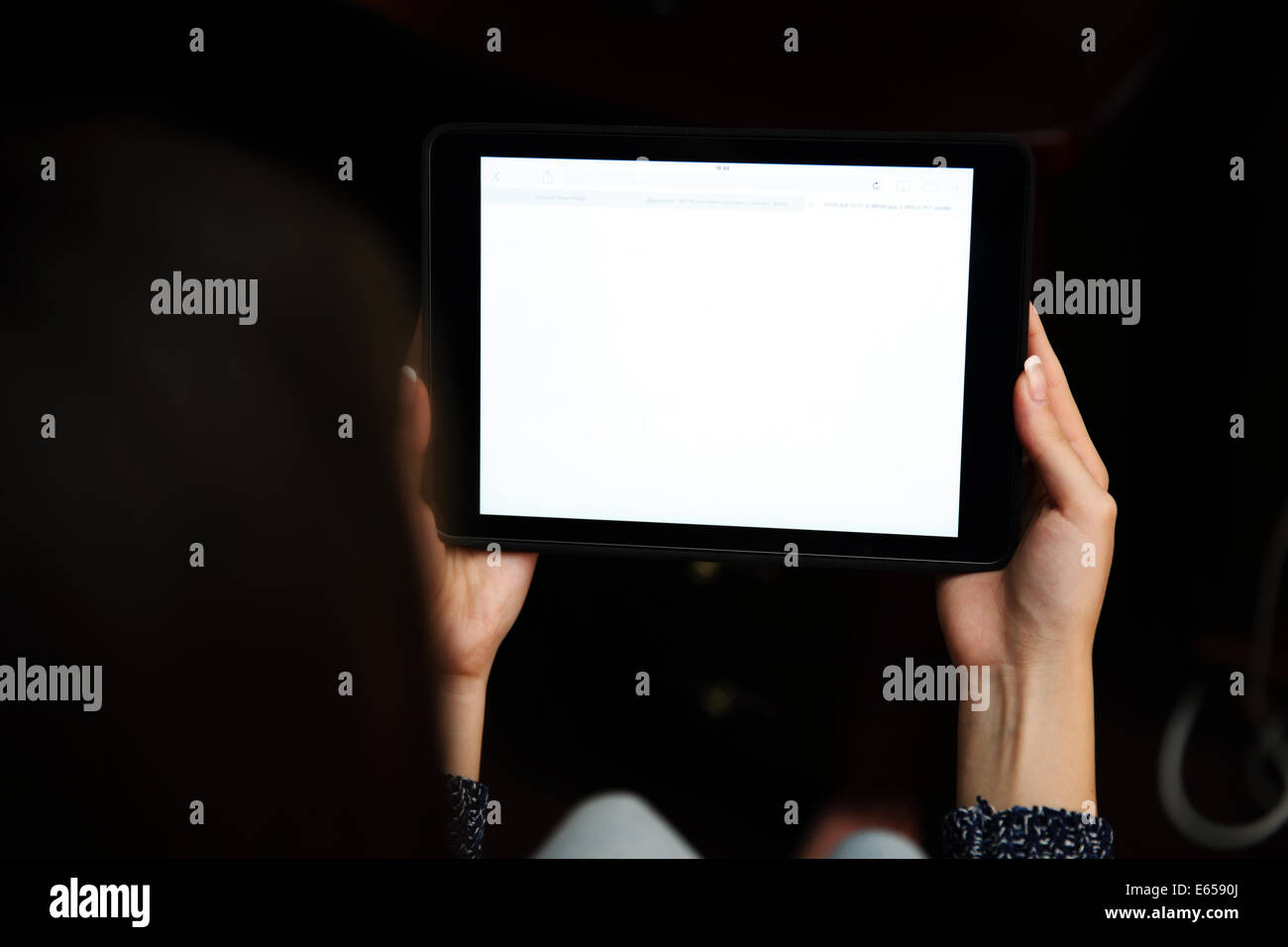 Back view portrait of a woman holding tablet computer Stock Photo
