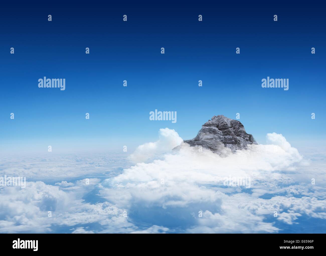 Mountain peak through the clouds Stock Photo
