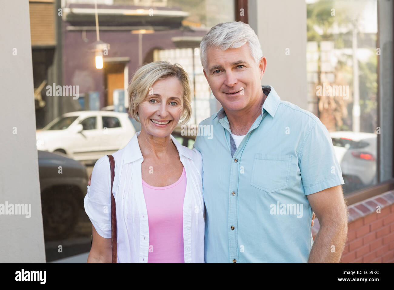 Happy mature couple smiling at camera in the city Stock Photo