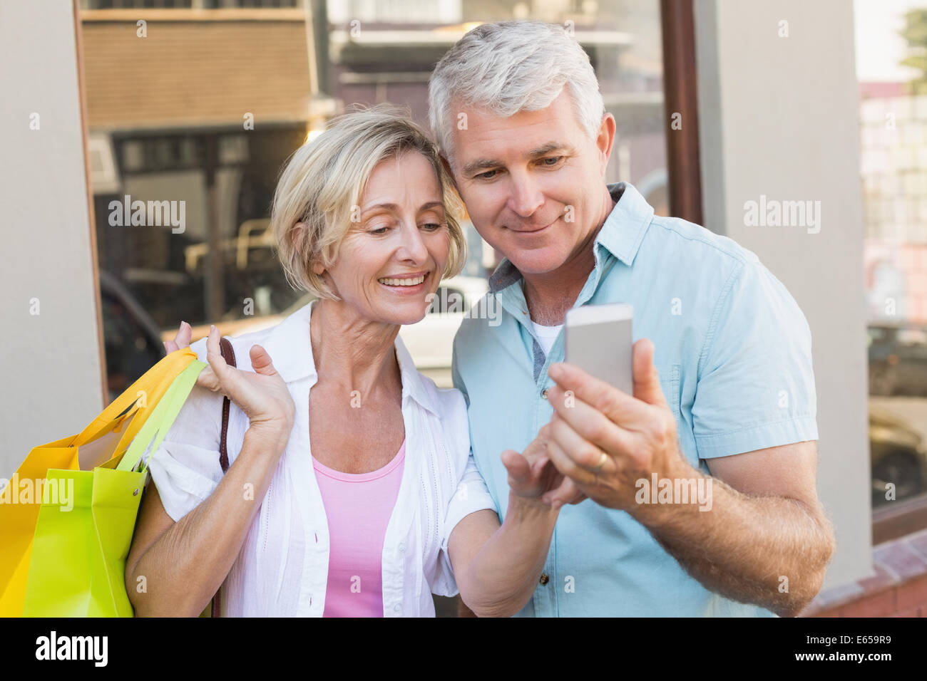 Happy mature couple looking at smartphone together Stock Photo