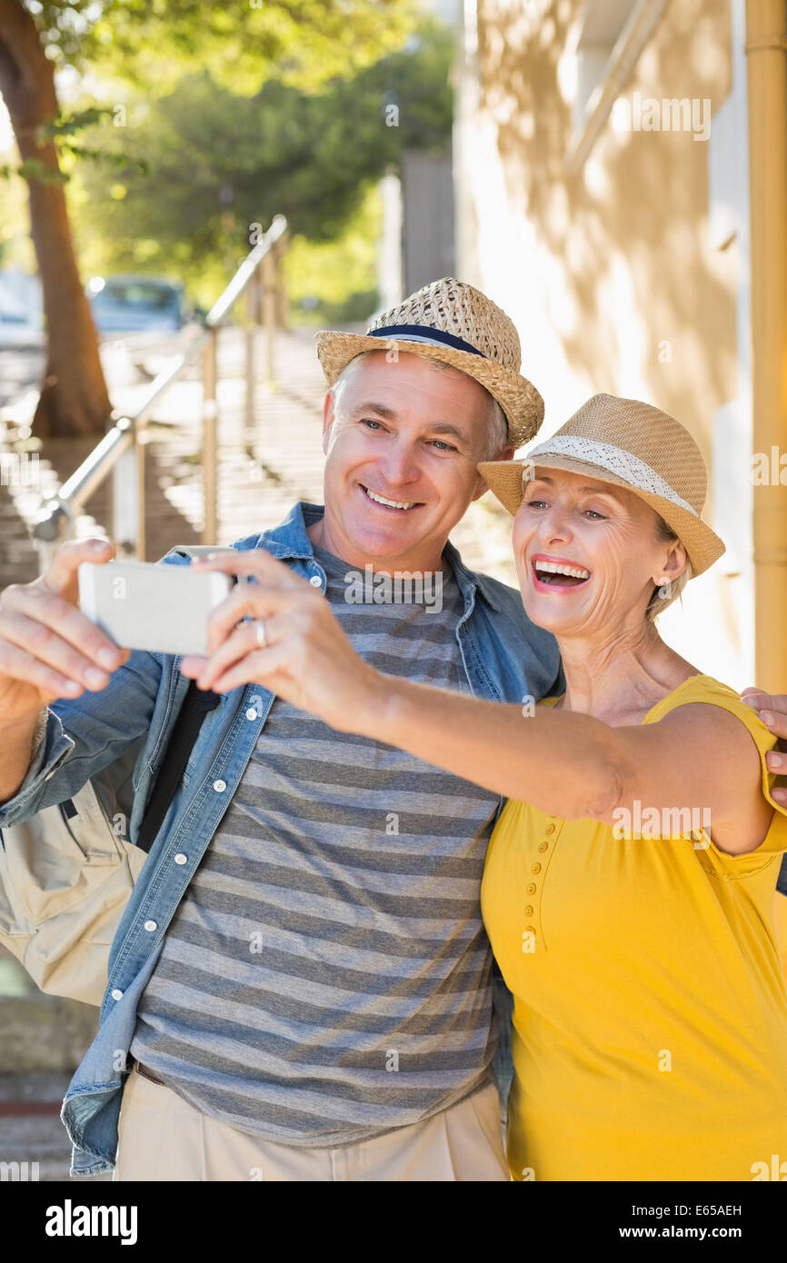 Happy mature couple taking a selfie together in the city Stock Photo