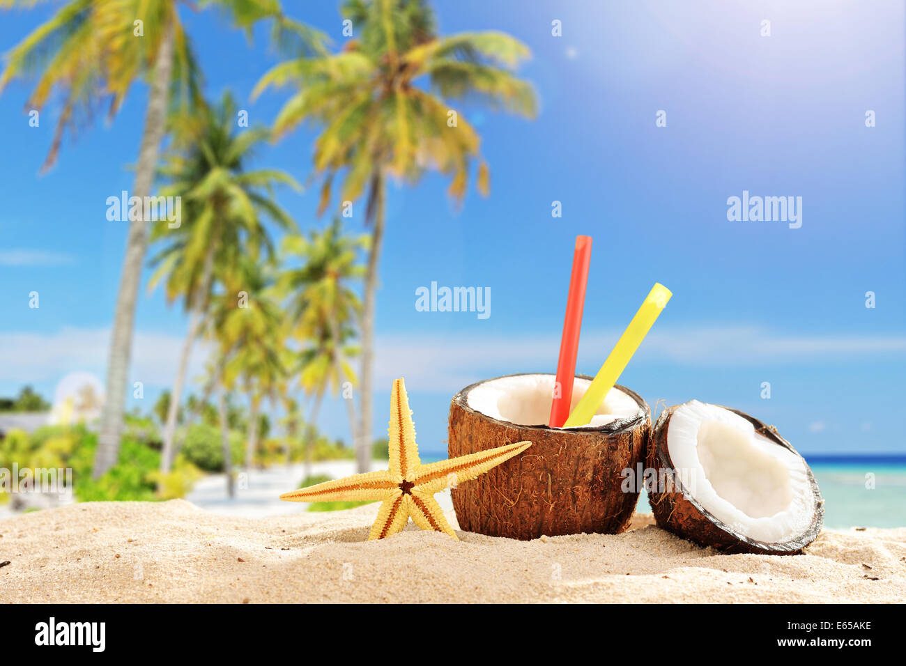 Coconut cocktail on a tropical beach in the summer with the ocean in