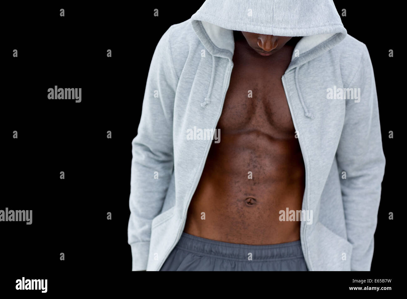 Muscular young man in hood jacket Stock Photo
